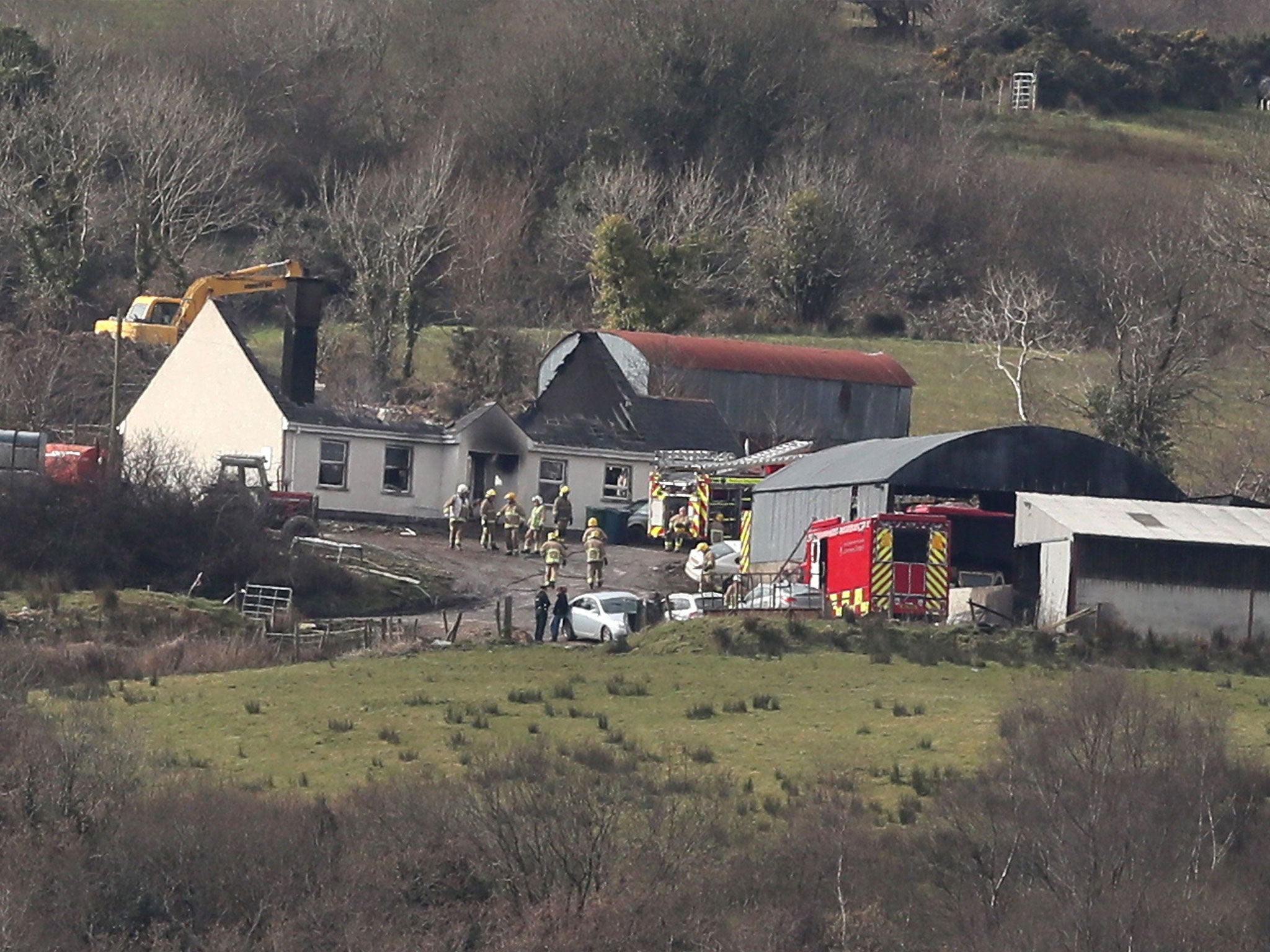 Emergency services at a house in Derrylin, where three people died in a fire