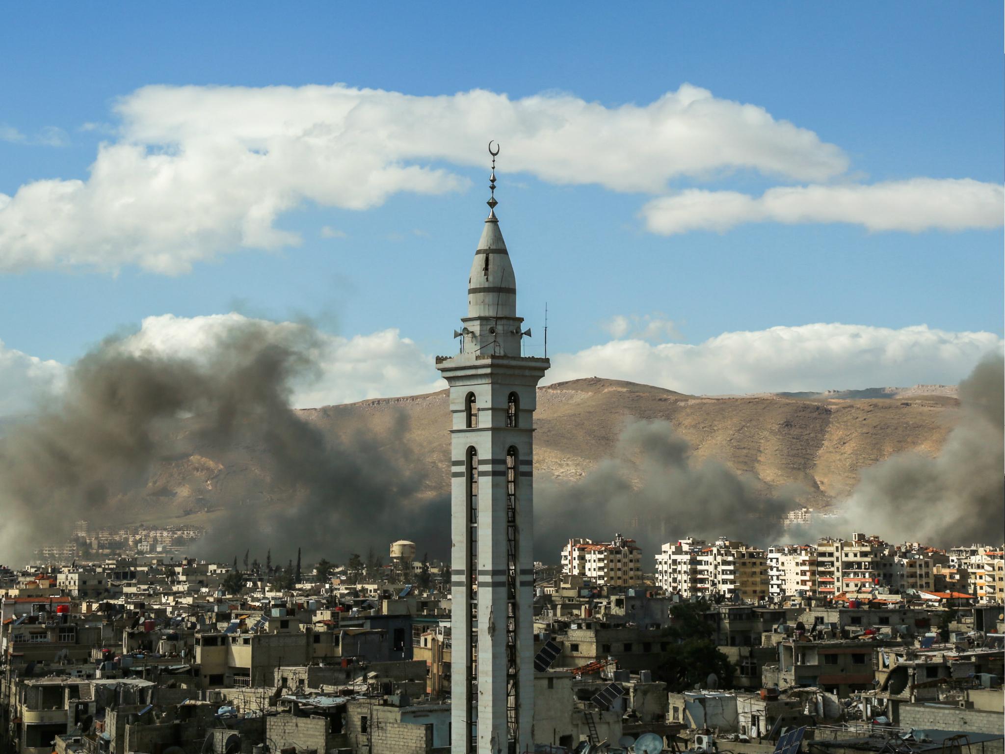 Smoke plumes rise during reported regime bombardment of Syrian rebel-held Douma, in the Eastern Ghouta region outside Damascus on 27 February 2018.