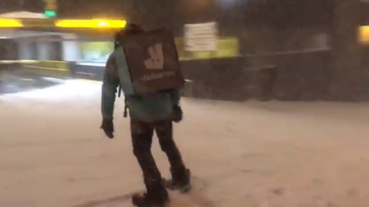 A Deliveroo rider spotted snowboarding in Glasgow