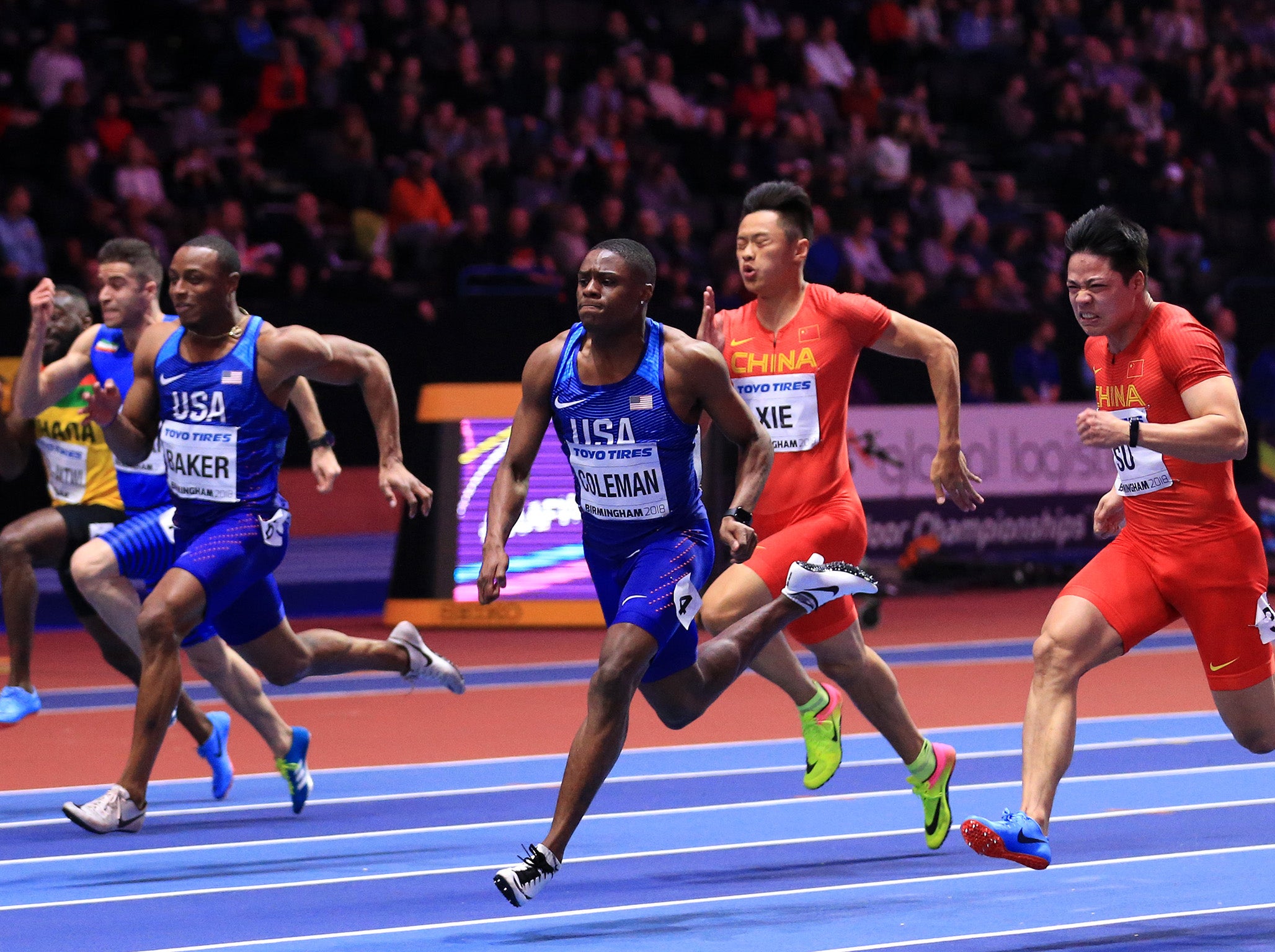 Christian Coleman, centre, beats Su Bingtian, right, to 60m gold