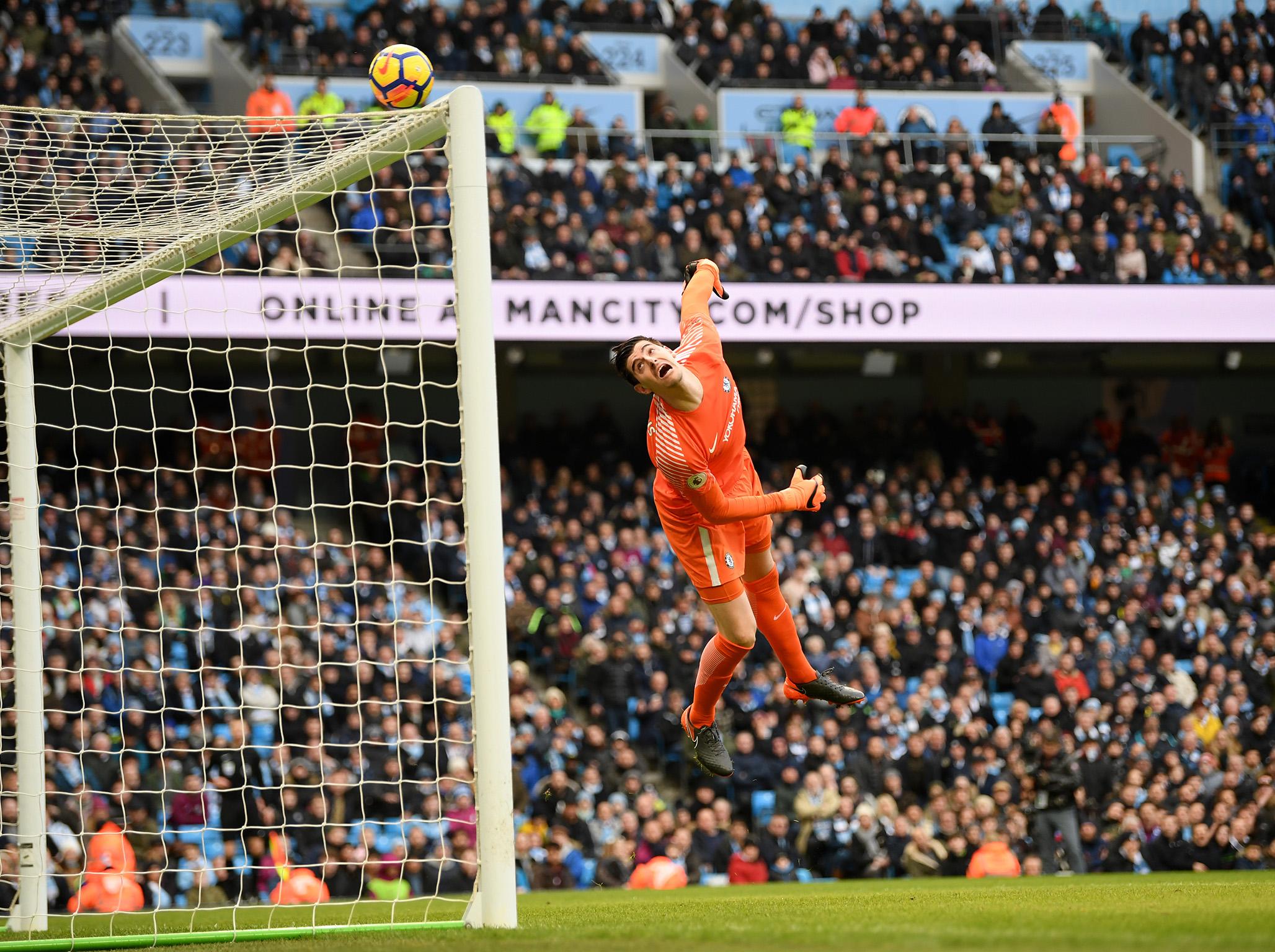 Thibaut Courtois stretches as the ball loops over his bar