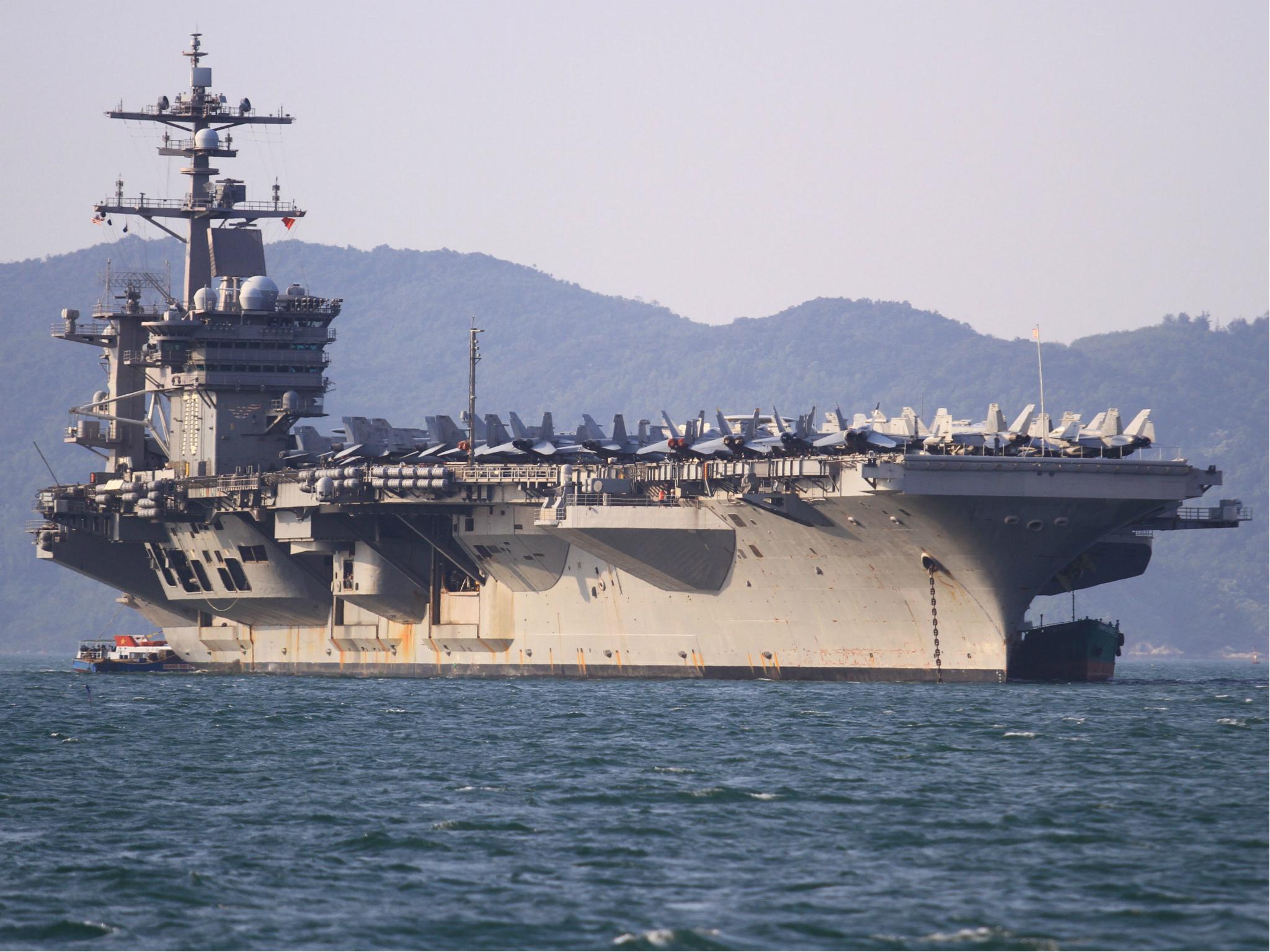 Military aircraft are seen parked on the flight deck of the USS Carl Vinson off the coast in Danang, Vietnam on 5 March 2018.