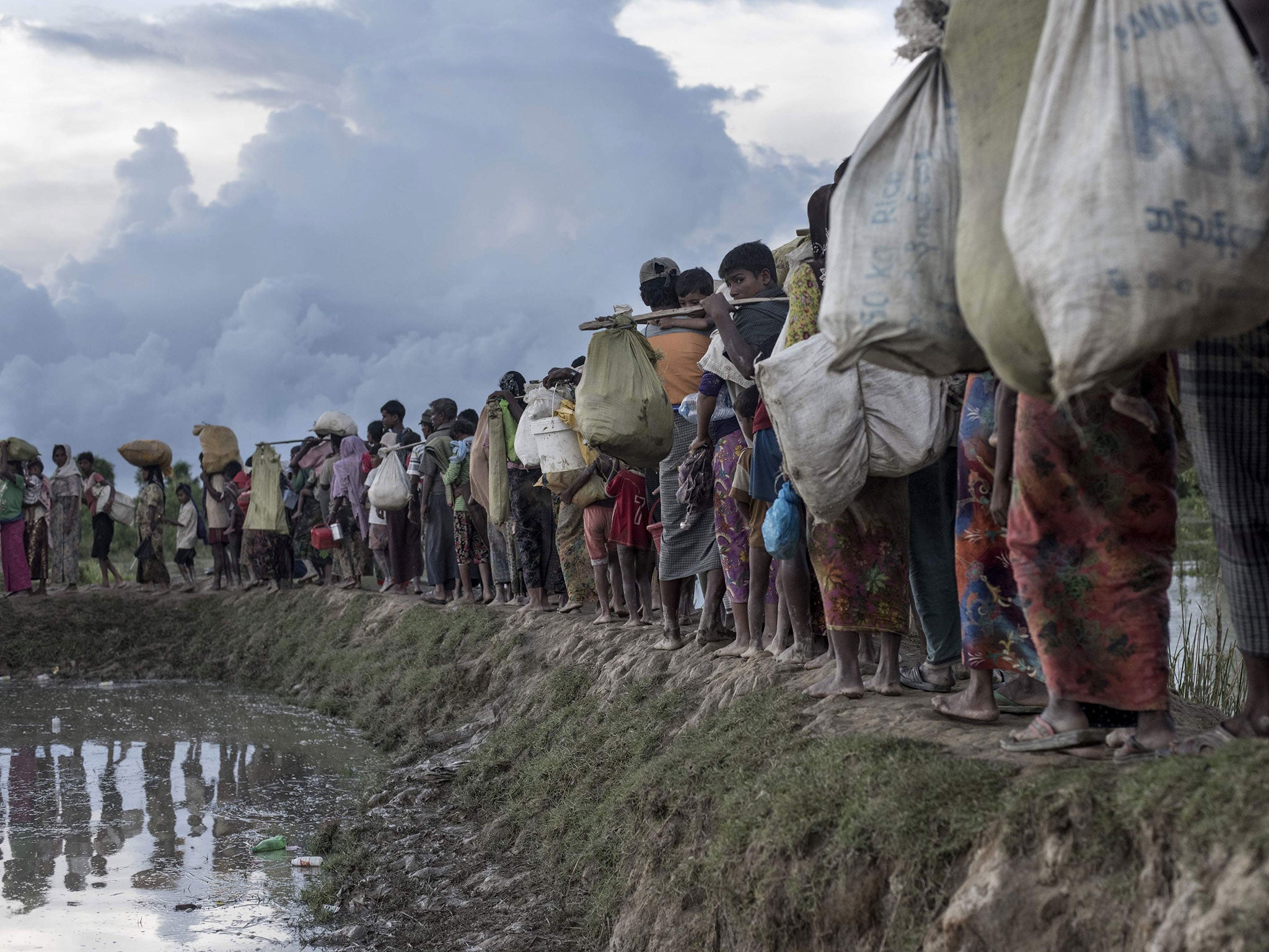 Rohingya refugees after crossing the Naf river from Myanmar into Bangladesh in Whaikhyang