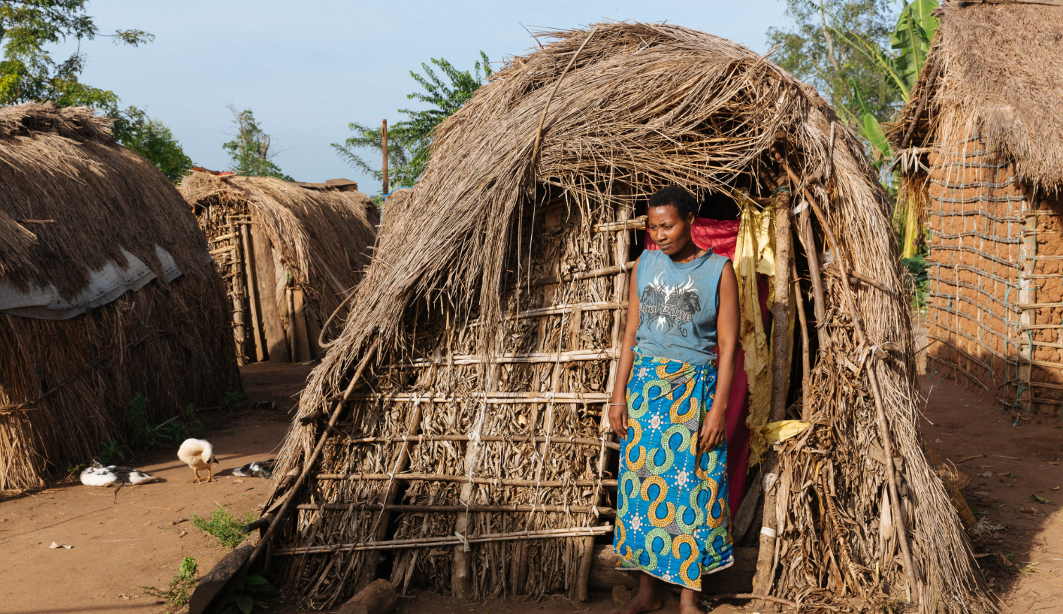 Patience outside her hut in the Kigyayo displacement camp (Womankind Worldwide)