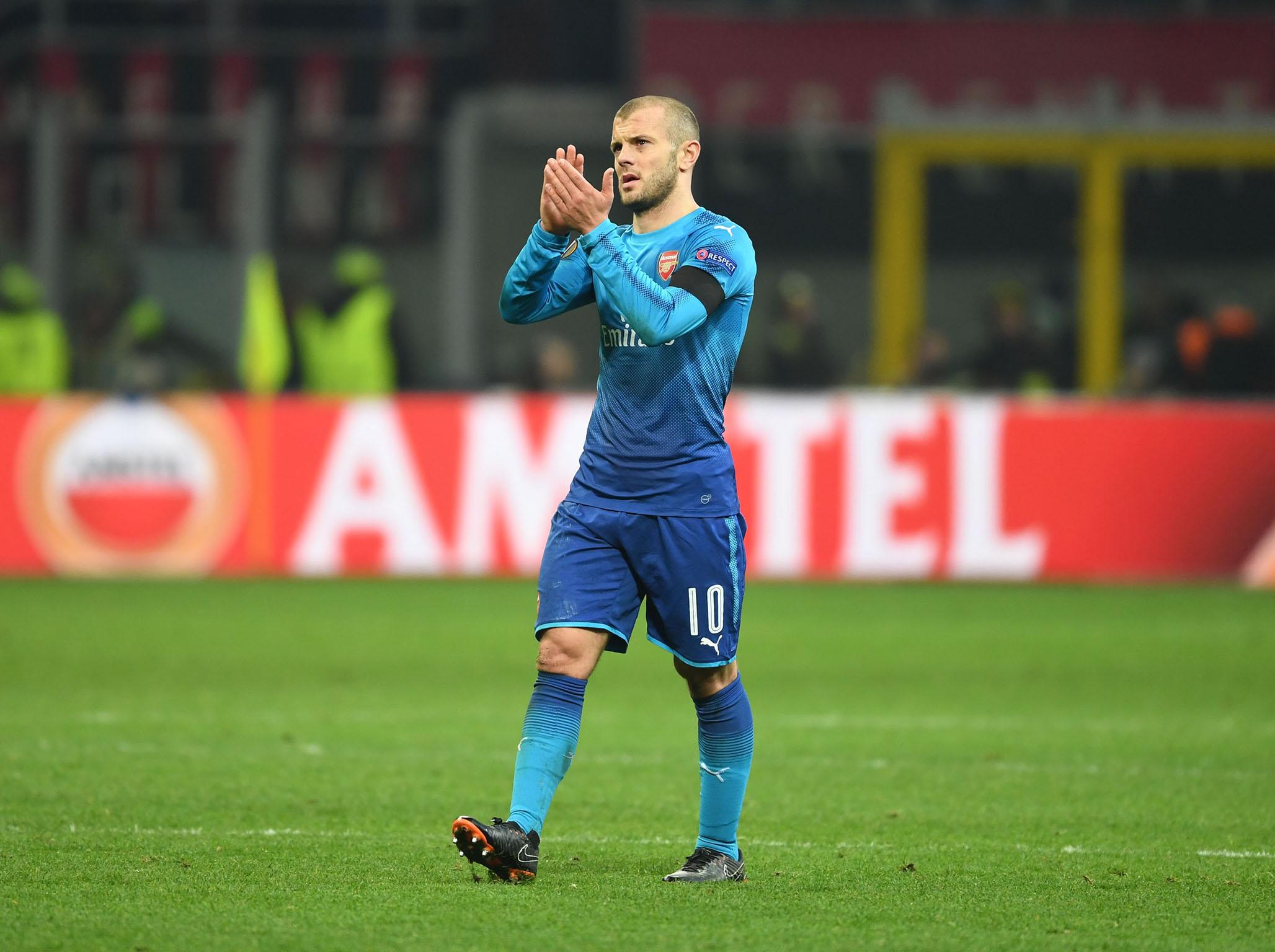 Jack Wilshere applauds fans after Arsenal’s win in Milan