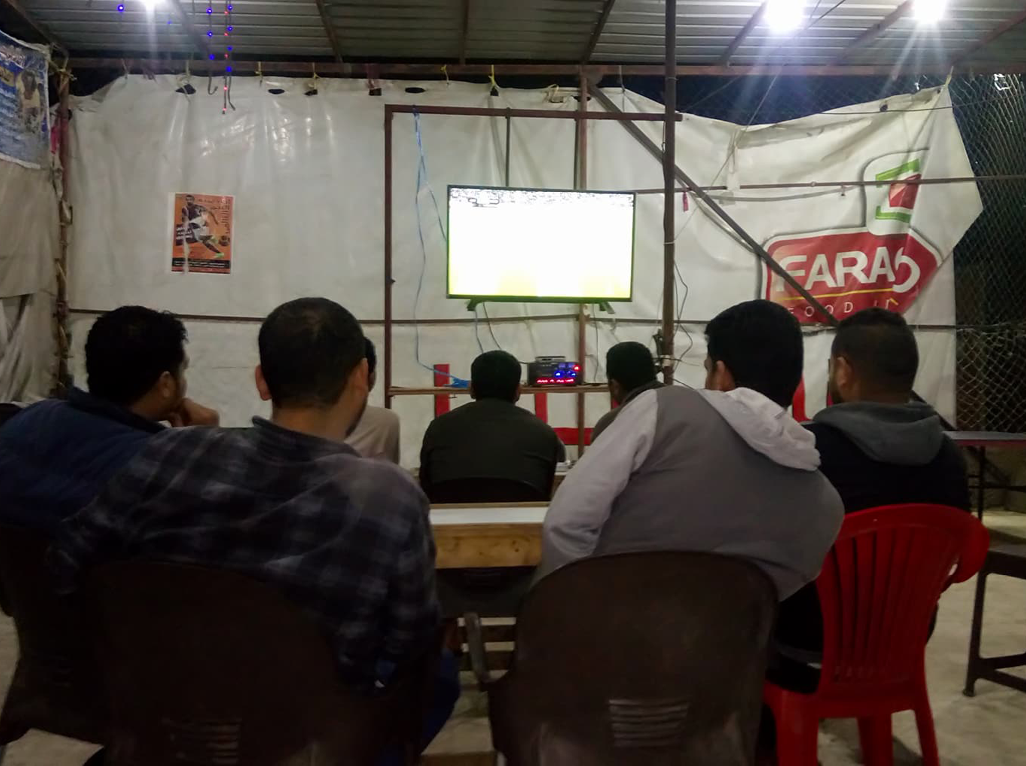 &#13;
Fans watch Salah in action in Nagrig village (Edmund Bower)&#13;