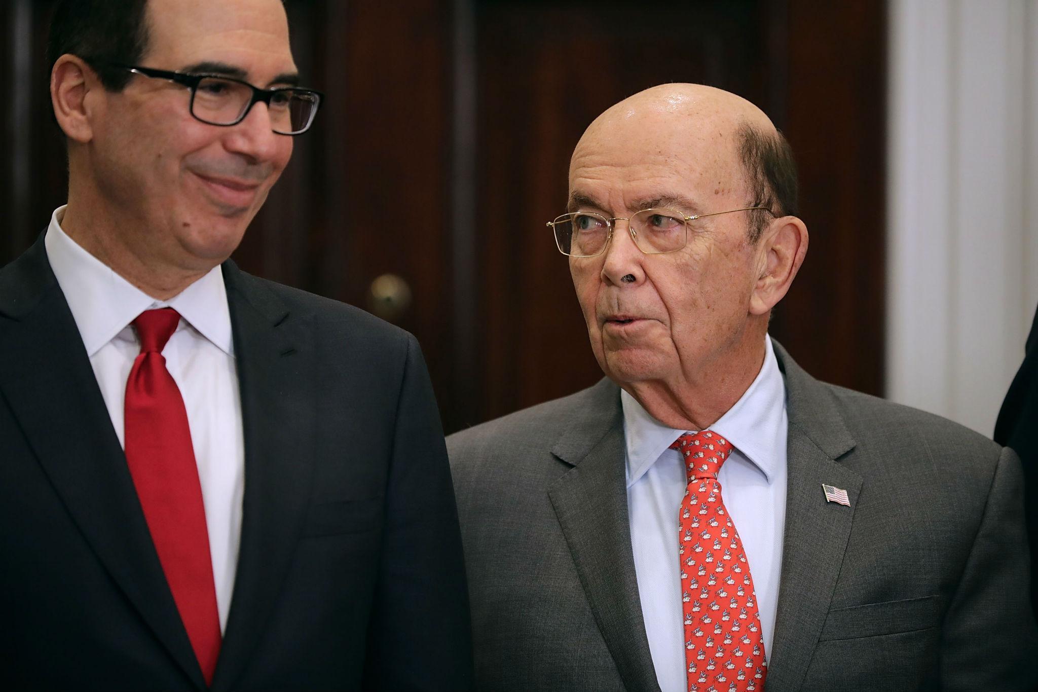 Treasury Secretary Steven Mnuchin and Commerce Secretary Wilbur Ross talk before President Donald Trump signs the 'Section 232 Proclamations' on steel and aluminium imports