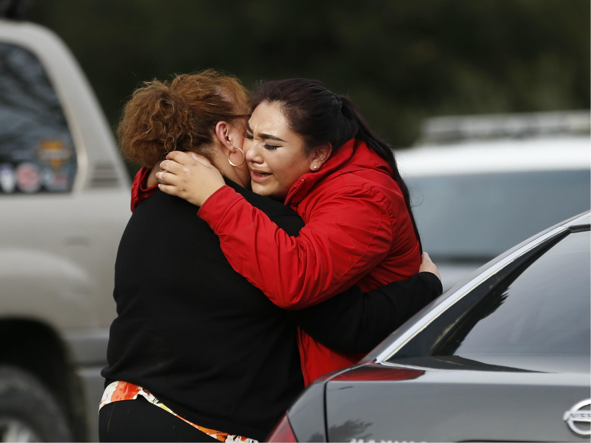 Vanessa Flores embraces another woman after she leaves the locked down Veterans Home of California during an active shooter turned hostage situation on 9 March 2018 in Yountville, California.