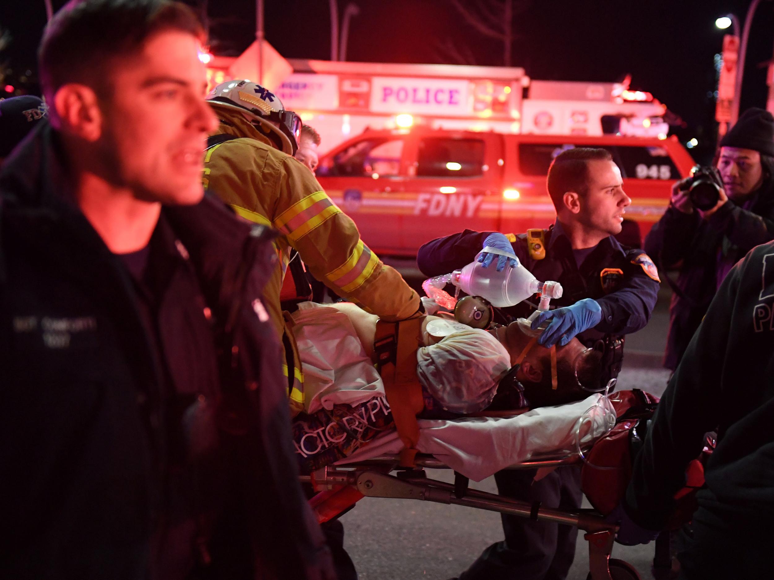 Paramedics and members of the NYFD perform CPR on a victim of the helicopter crash in New York.