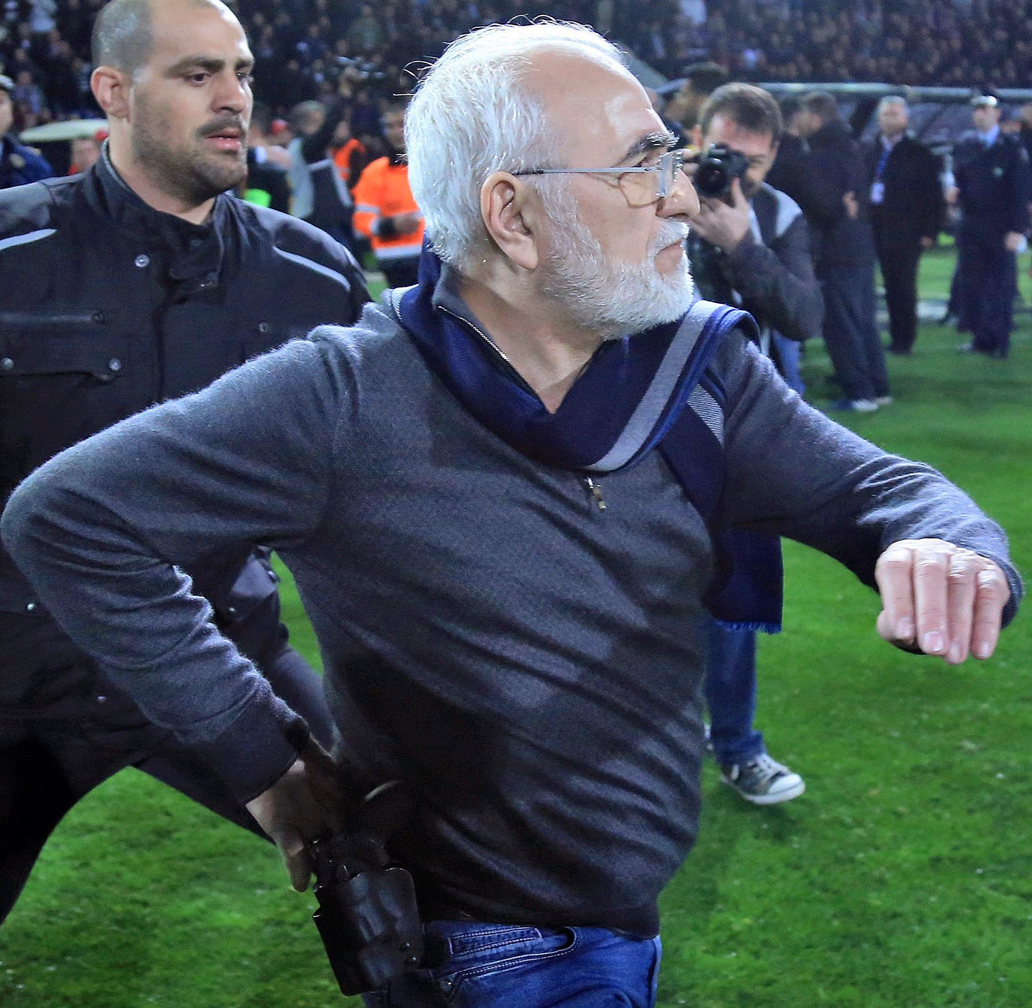 &#13;
PAOK president Ivan Savvidis is seen with his hand placed on a gun on his belt (AP)&#13;