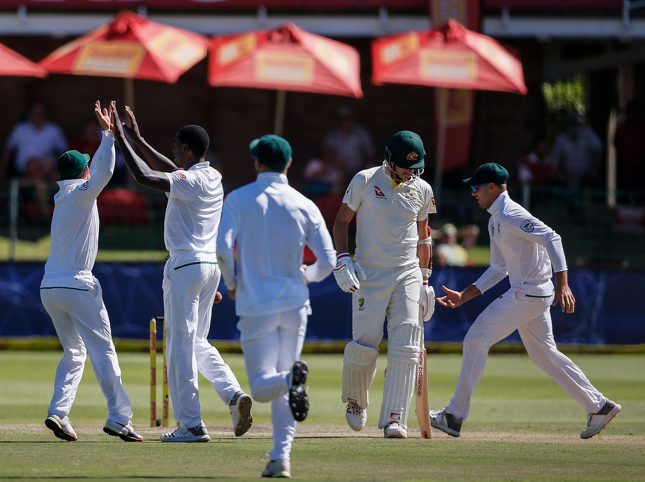 Kagiso Rabada, second left, celebrates the wicket of Pat Cummins