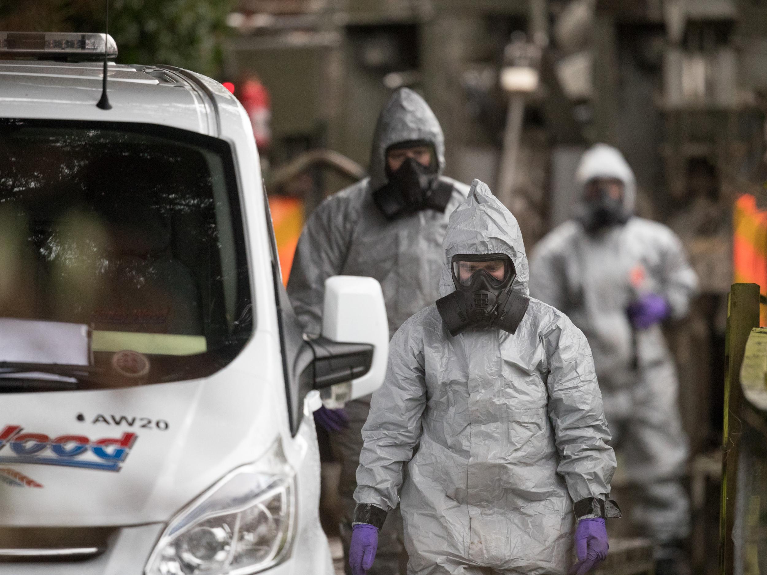 Investigators in protective clothing remove a van from an address in Winterslow near Salisbury