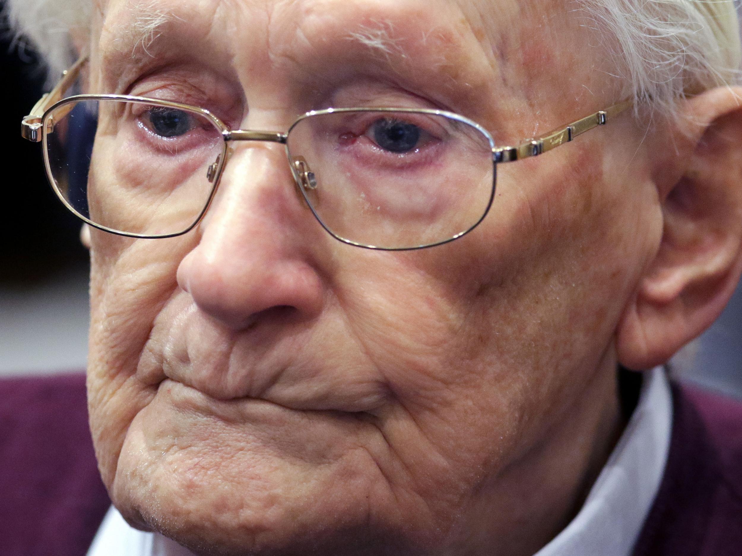 Former SS sergeant Oskar Groening listens to the verdict of his trial at a court in Lueneburg, northern Germany