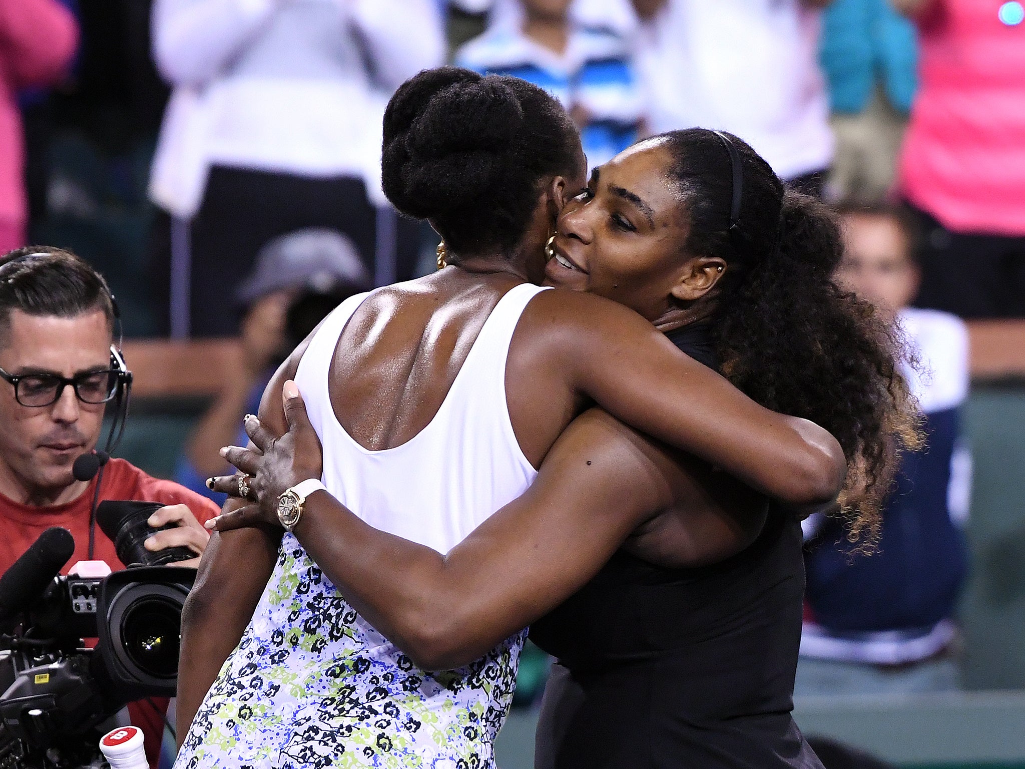 The Williams sisters embrace after Venus' victory over Serena at Indian Wells