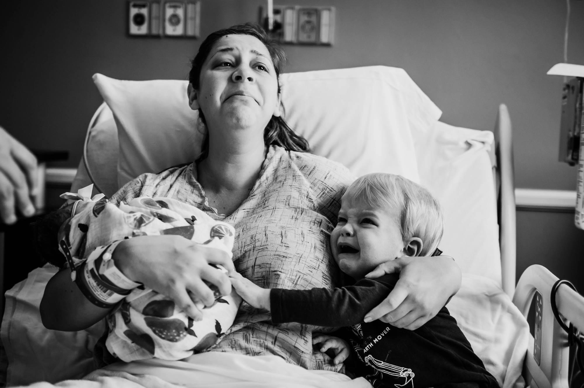 A series of photos of a young boy crying hysterically when meeting his baby sister for the first time has gone viral