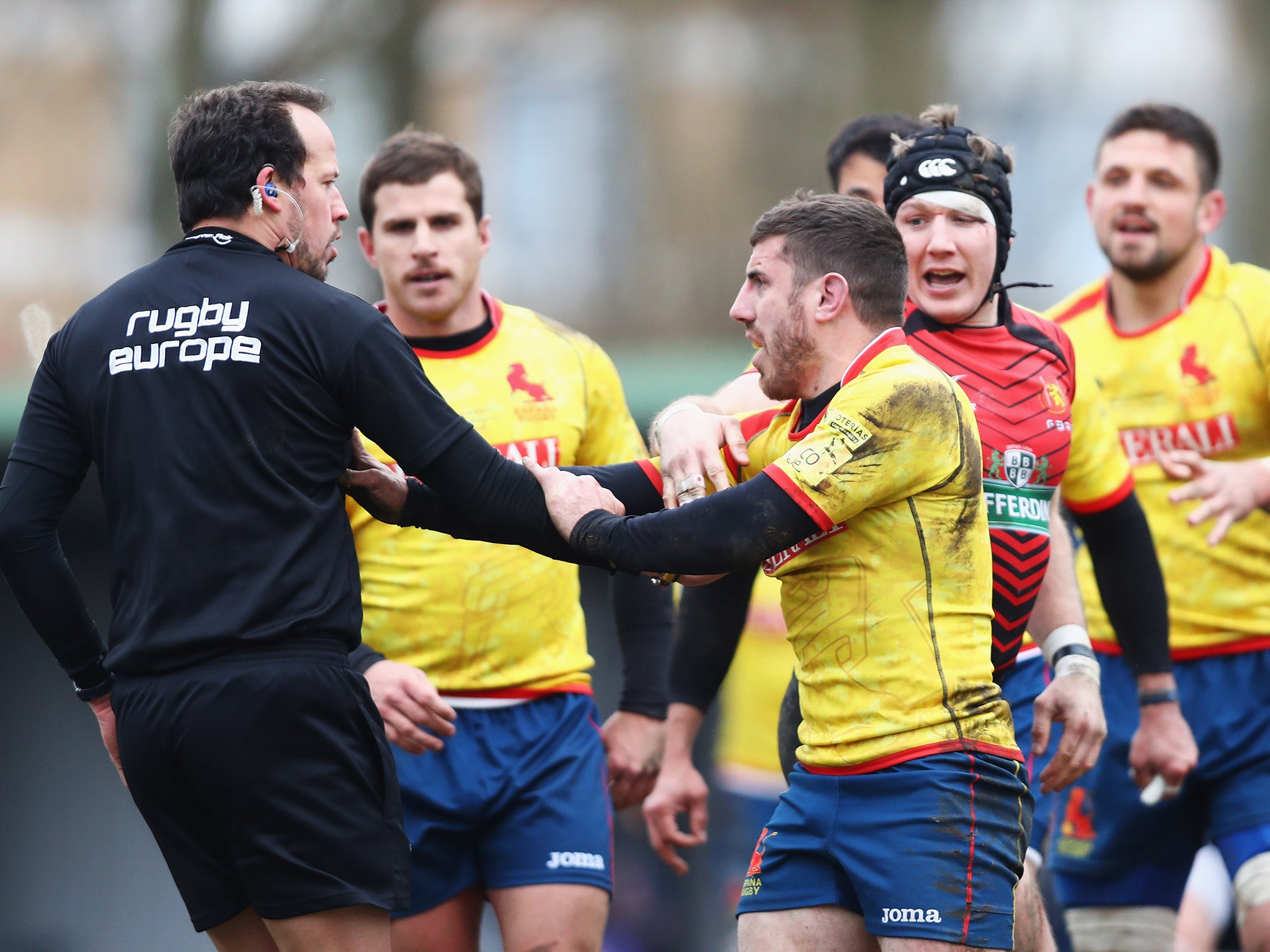 Vlad Iordachescu is pursued by Spain players after their defeat by Belgium