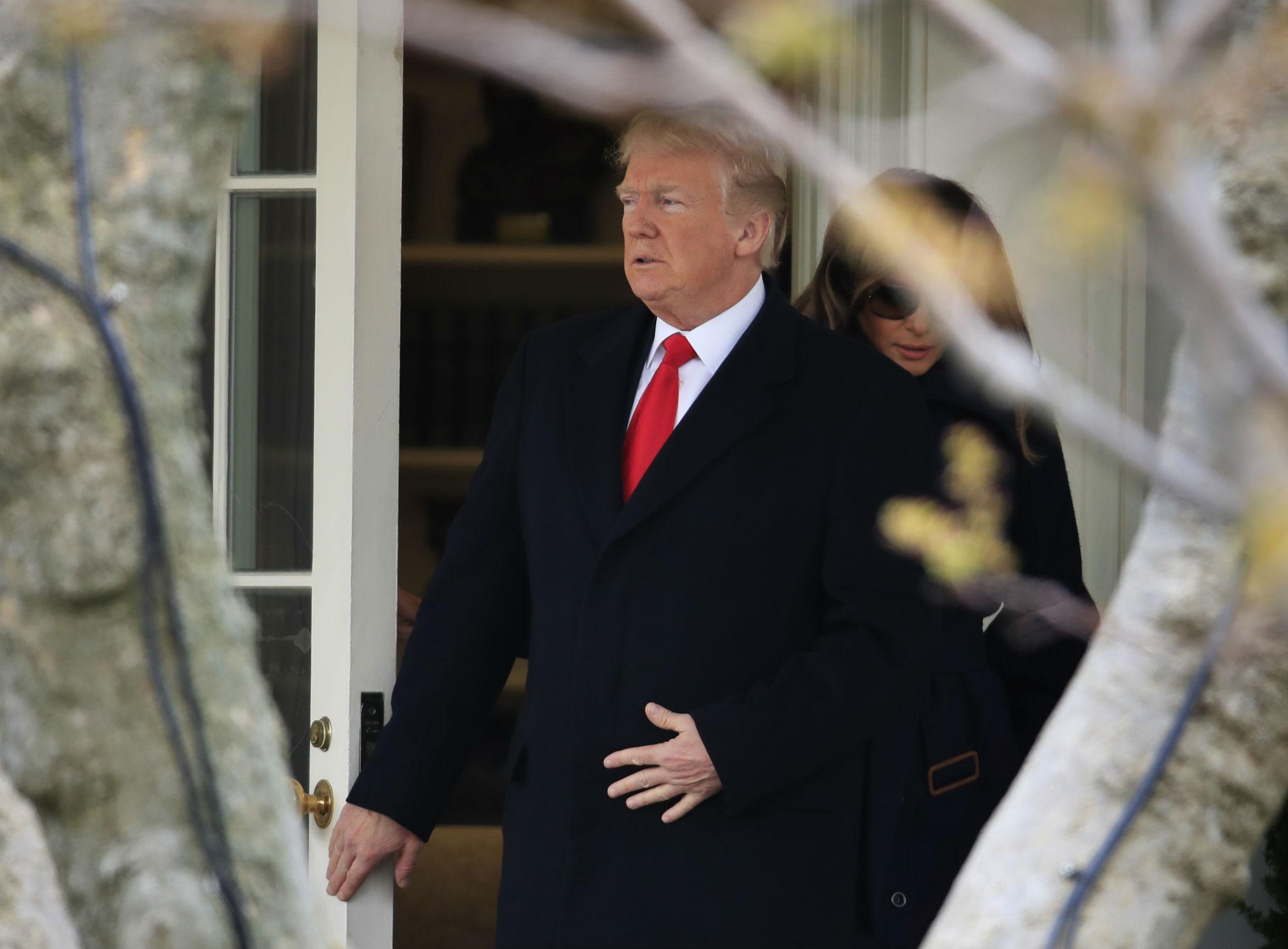 Donald Trump exits the White House with his wife, First Lady Melania Trump