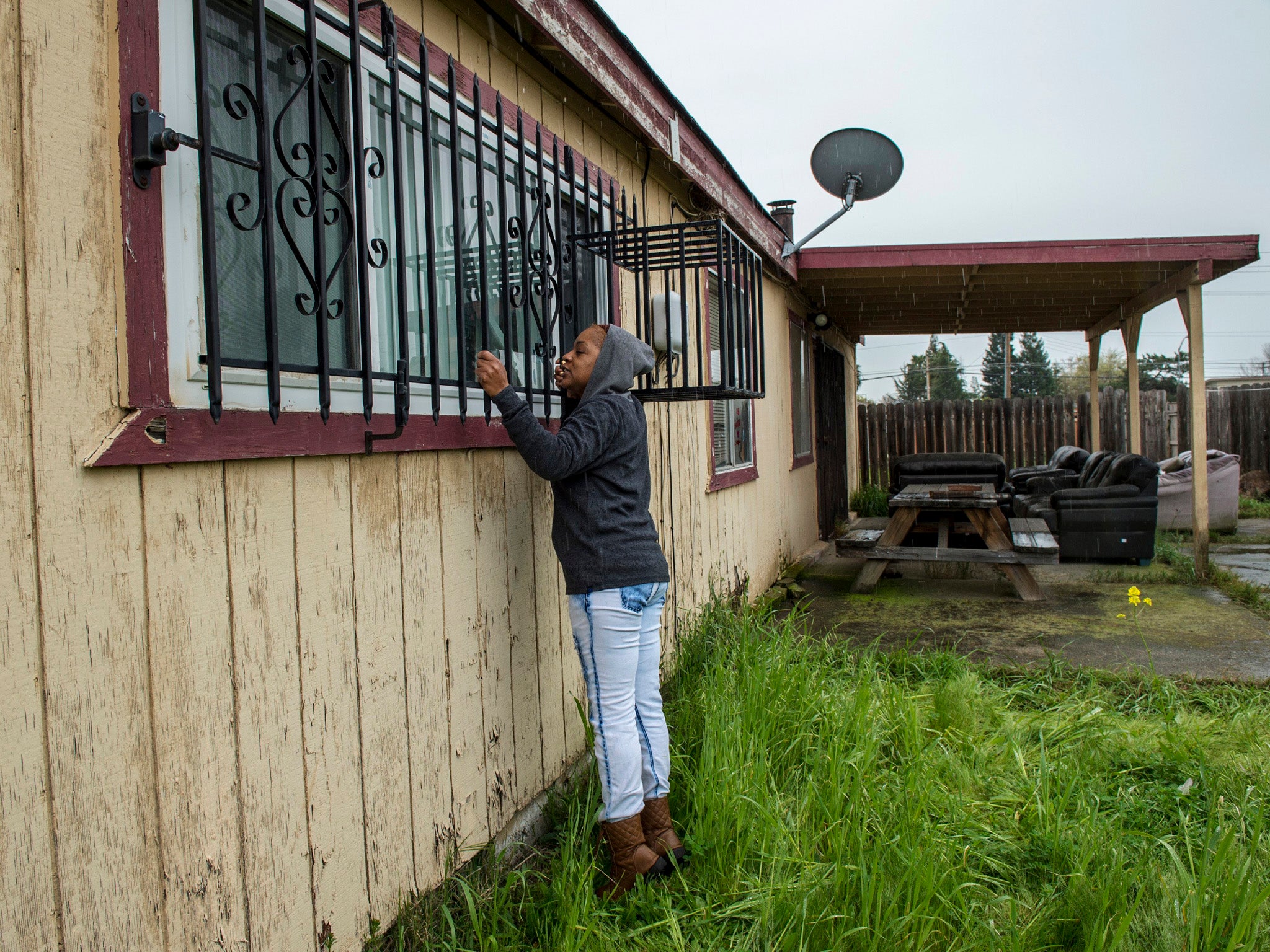 Lashunda Britt, a cousin of Stephan Clark, stands near where he was fatally shot by police in Sacramento