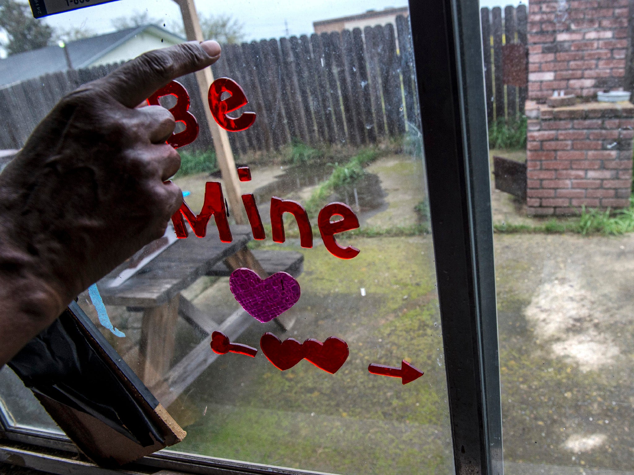 Sequita Thompson points to the white area on the patio where she said her grandson Stephon Clark lay dead after being shot by police in Sacramento (AP)