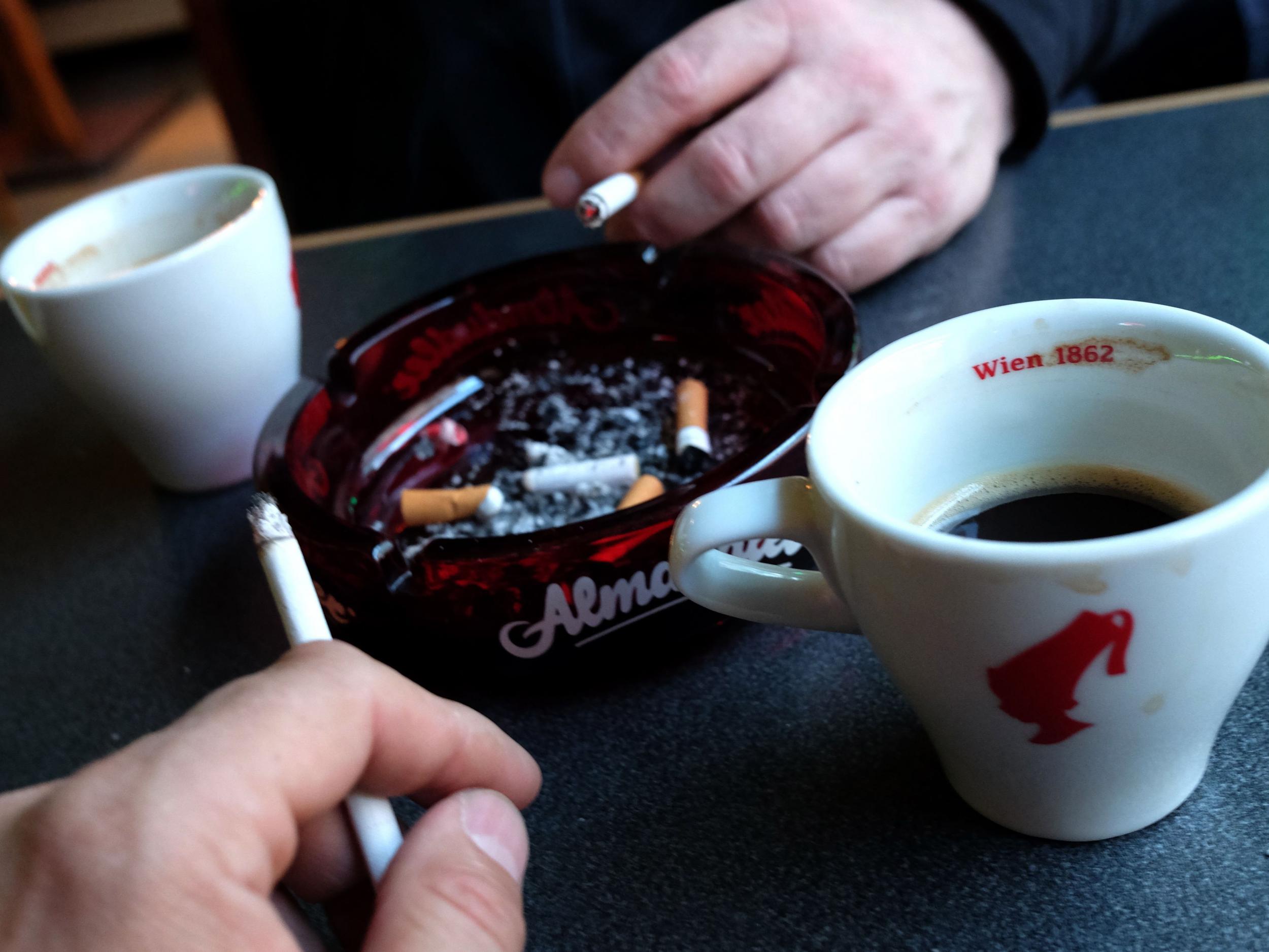 Guests of a Vienna's Cafe/Bar smoke cigarettes with their drinks