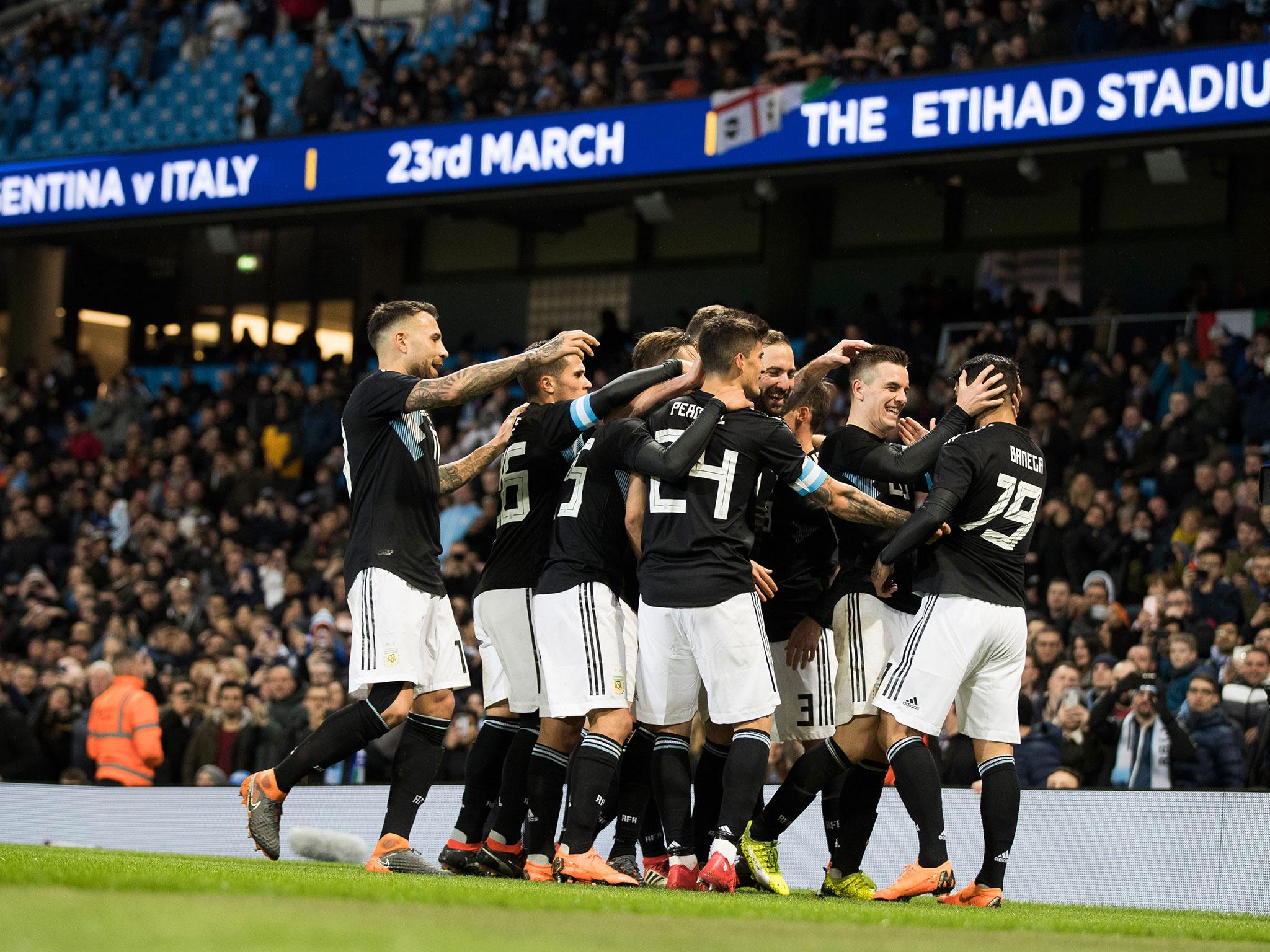 Ever Banega celebrates with teammates after opening the scoring for Argentina