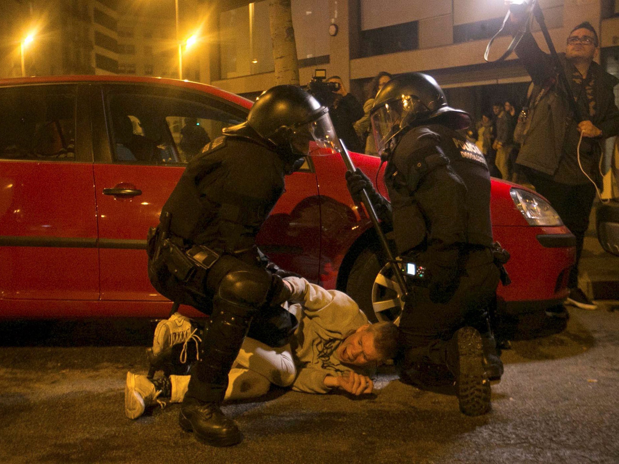 Catalonian riot police members and protesters clash during a protest against the detention of former Catalan leader Carles Puigdemont