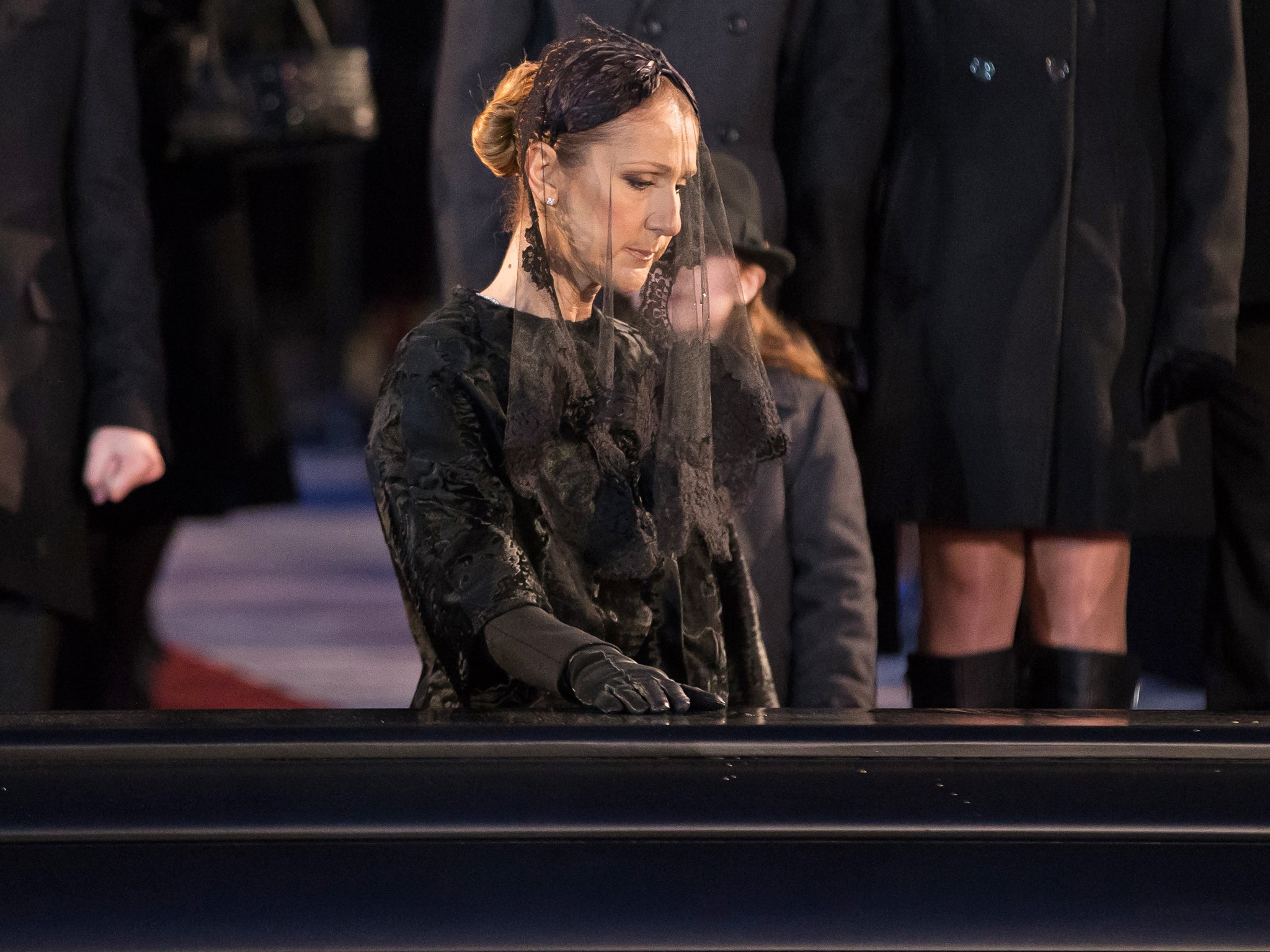 Public mourning: Céline Dion pauses at the casket of her late husband René Angélil – his funeral was livestreamed