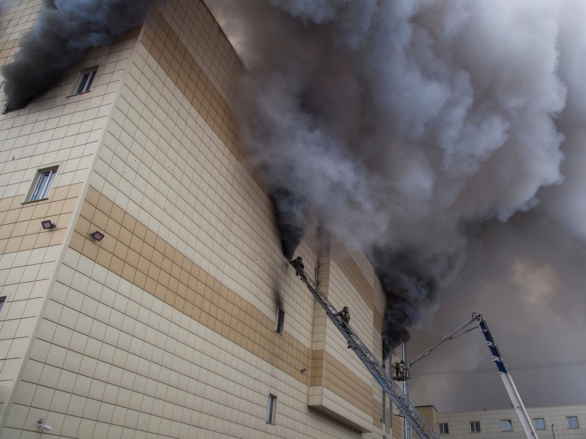 Members of the Emergency Situations Ministry work to extinguish a fire in the shopping centre