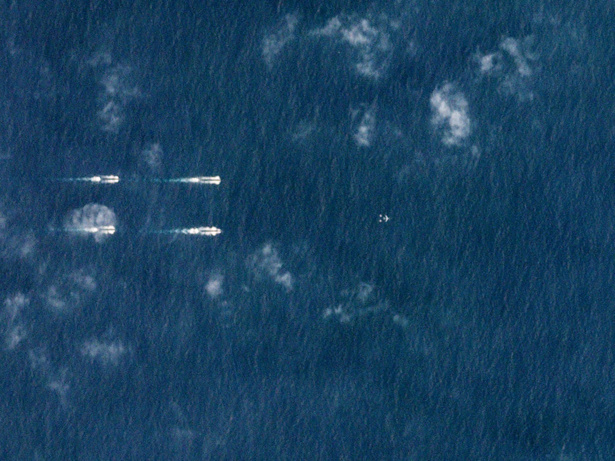 Satellite images show what appeared to be at least 40 ships and submarines flanking the carrier, ‘Liaoning’, supported by aircraft above