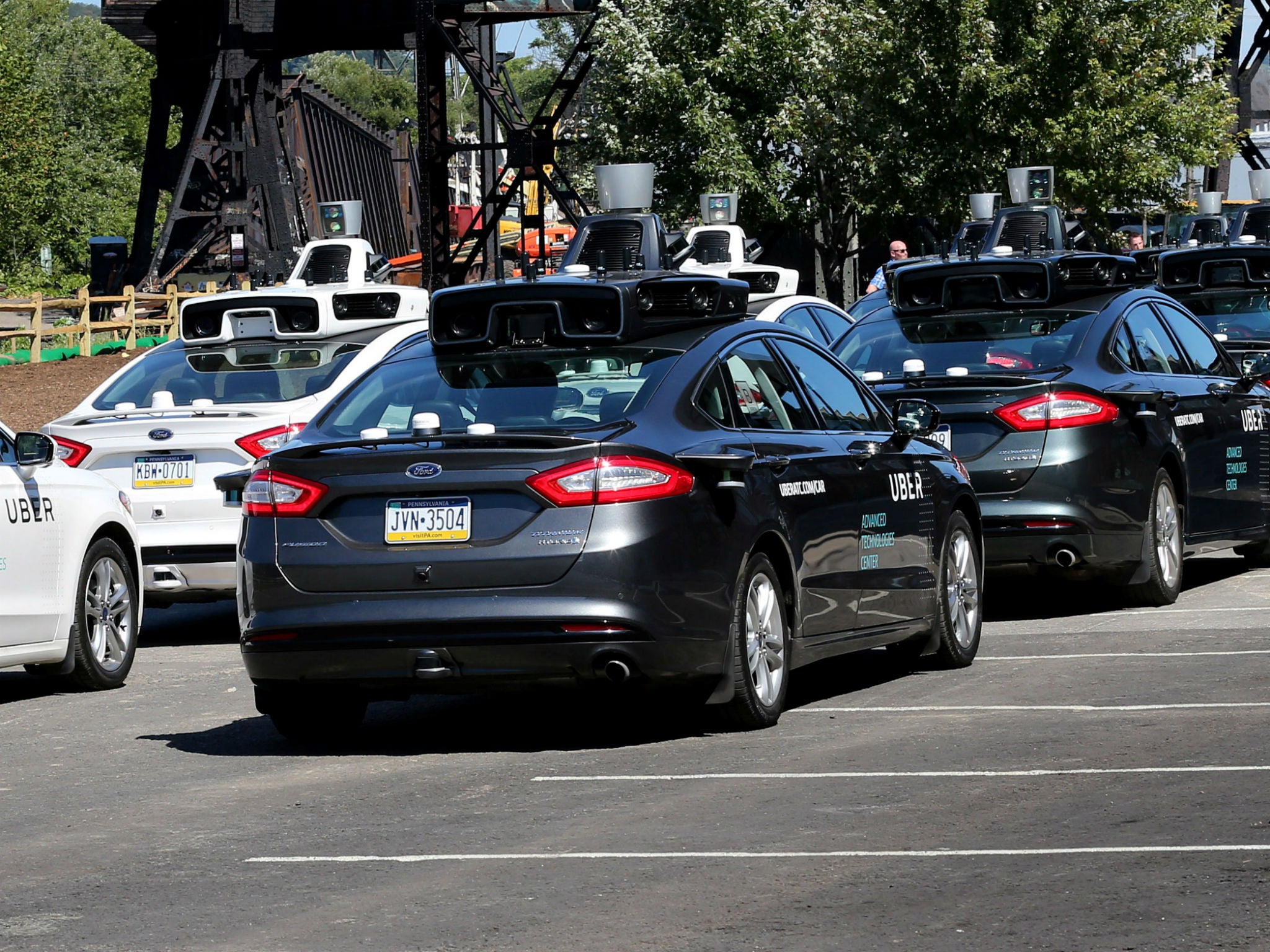 A fleet of Uber’s Ford Fusion driverless cars are shown during a demonstration of self-driving automotive technology in Pittsburgh, Pennsylvania