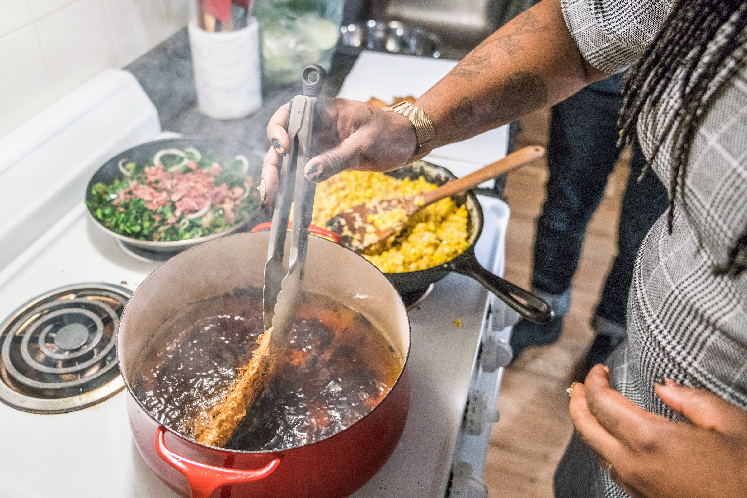 Garza fries tilapia while reflecting on the relationship between her activism and cooking