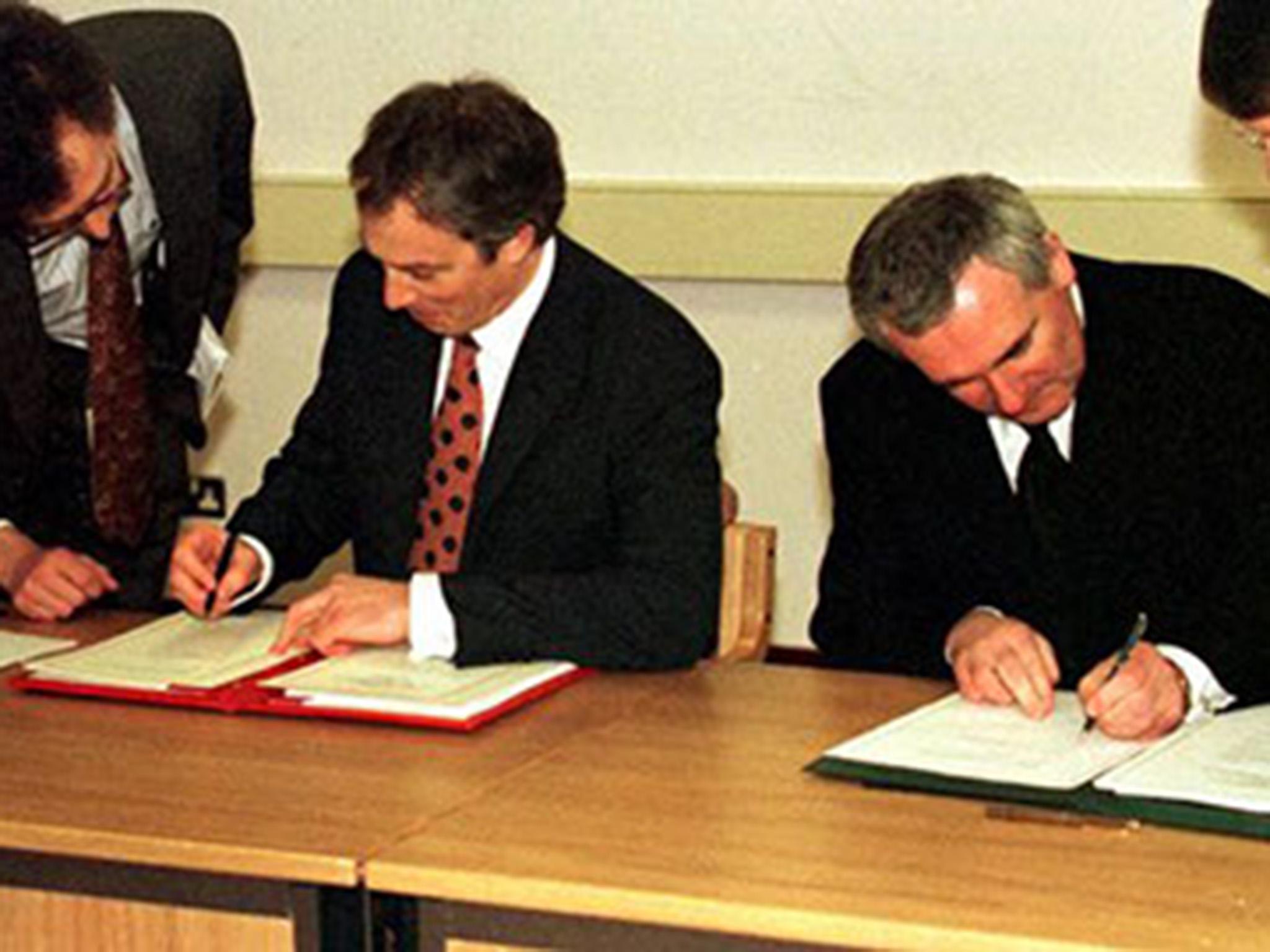 UK prime minister Tony Blair and the Irish taoiseach Bertie Ahern sign the Good Friday Agreement in 1998