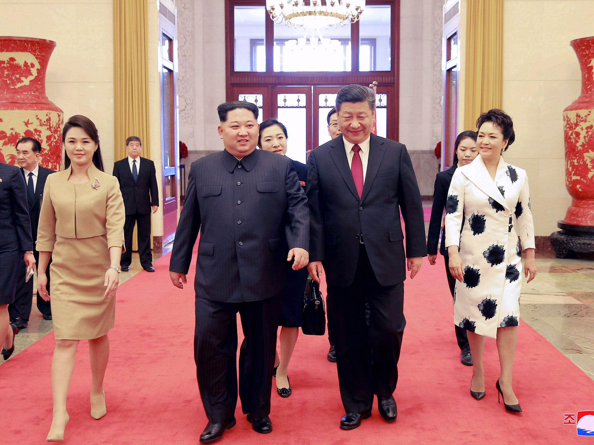 Ri Sol-ju with her husband, Kim Jong-un, as they walk with China's president, Xi Jinping, and his wife, Peng Liyuan