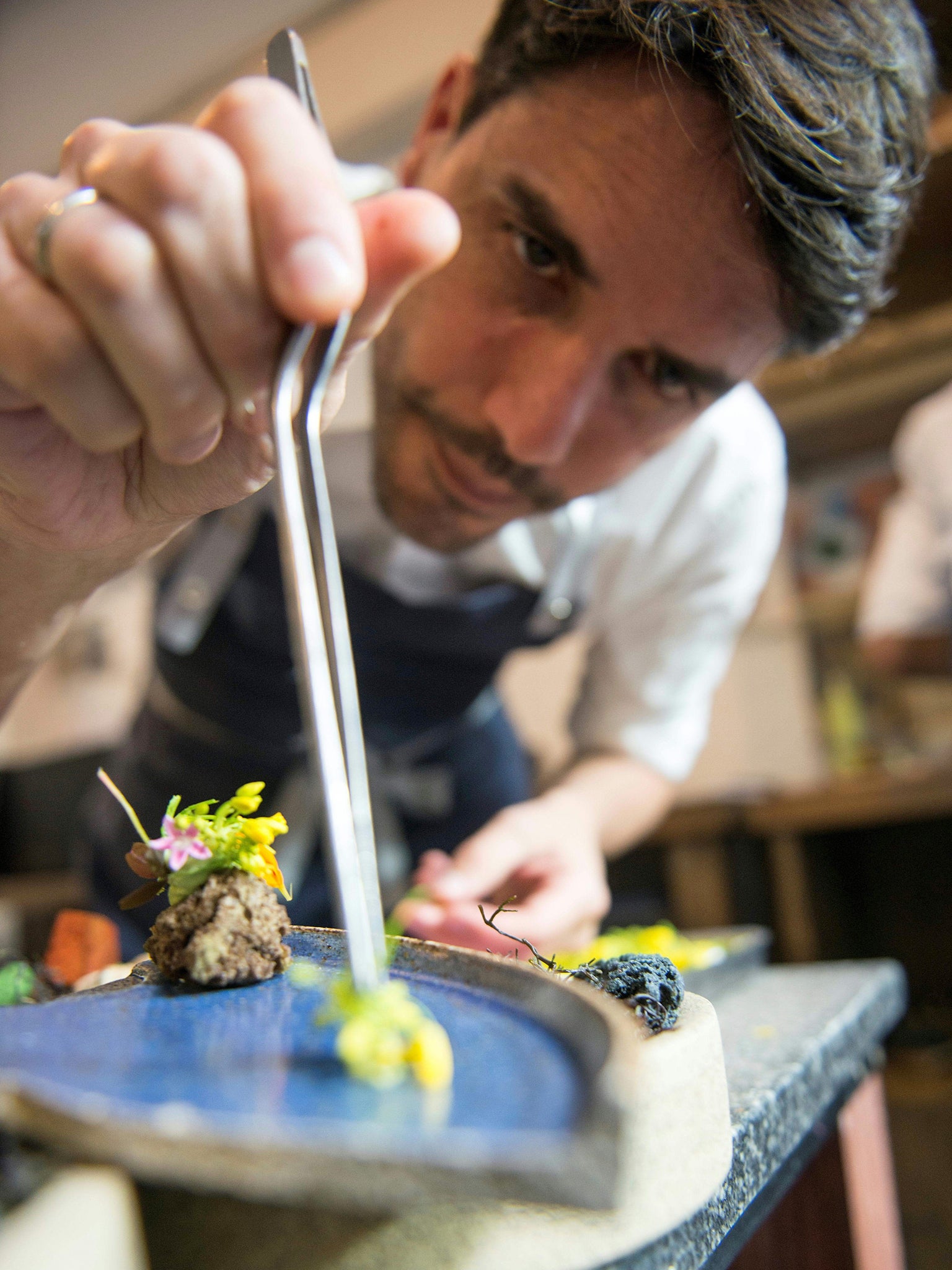 Martinez dresses a plate in his restaurant in Lima