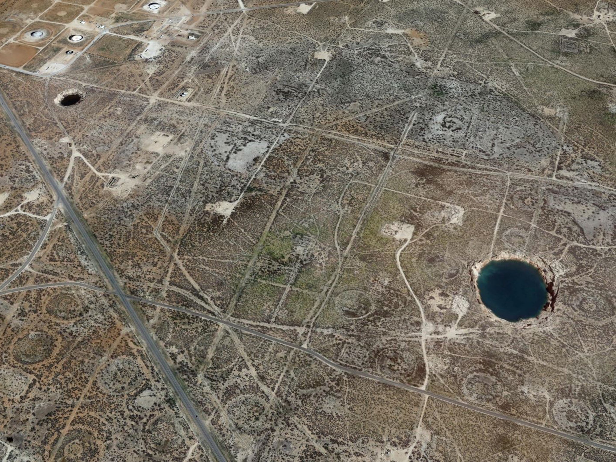 Two massive sinkholes near the town of Wink, Texas, have been linked to past fossil fuel extraction in the region