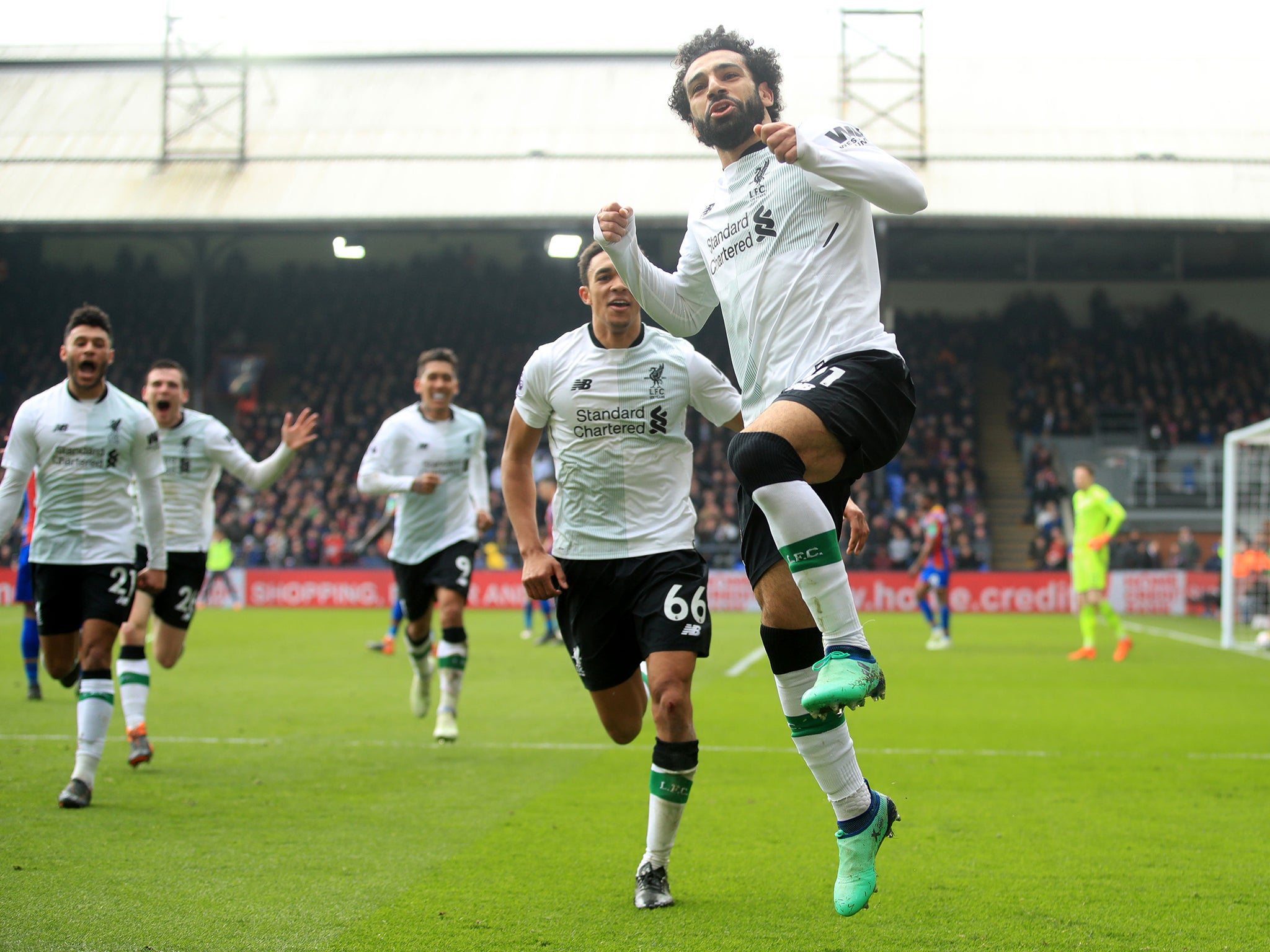 Mohamed Salah leaps into the air after scoring the winning goal