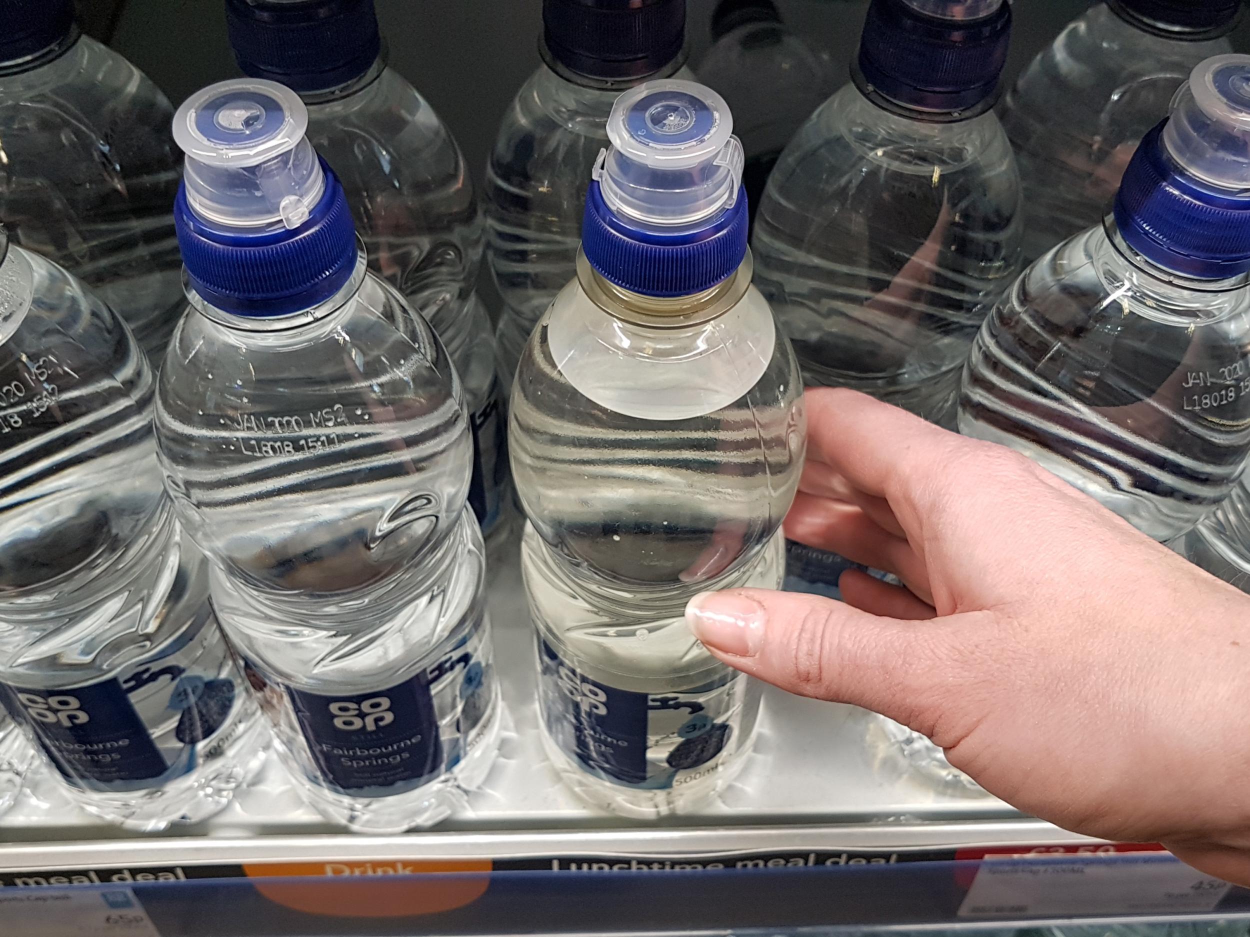 The new part-recycled plastic bottle has a slight but noticeable cloudy-grey appearance