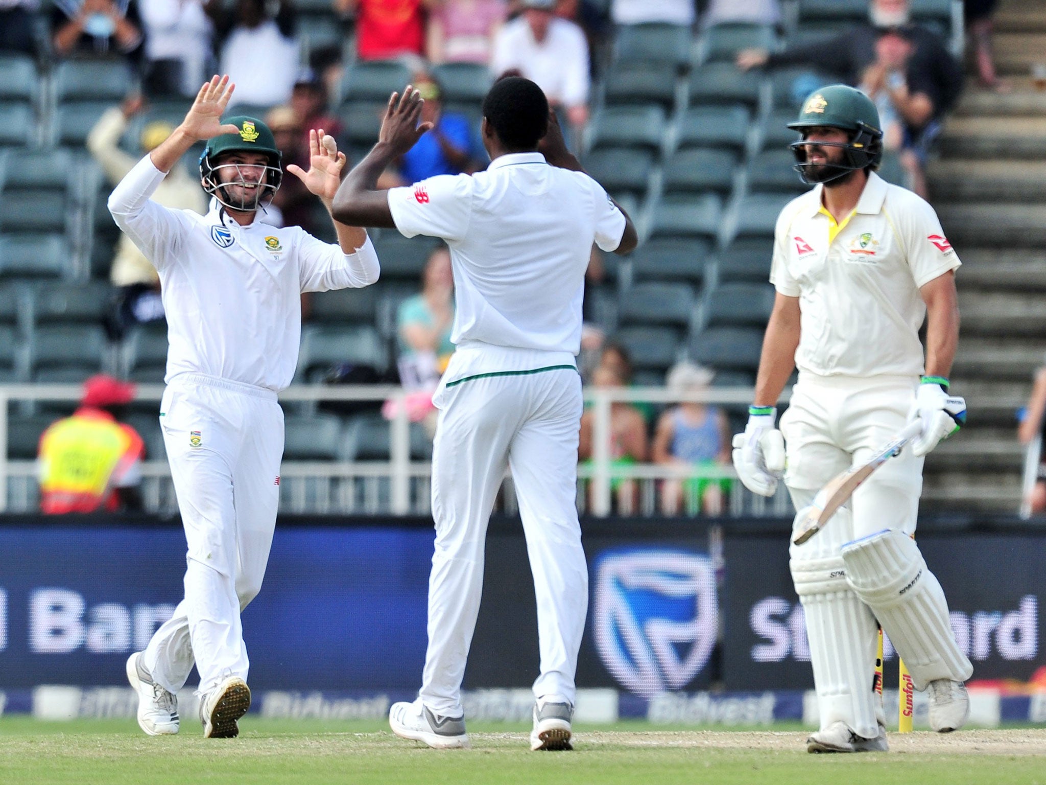 Kagiso Rabada celebrates with Aiden Markram after taking the wicket of Joe Burns