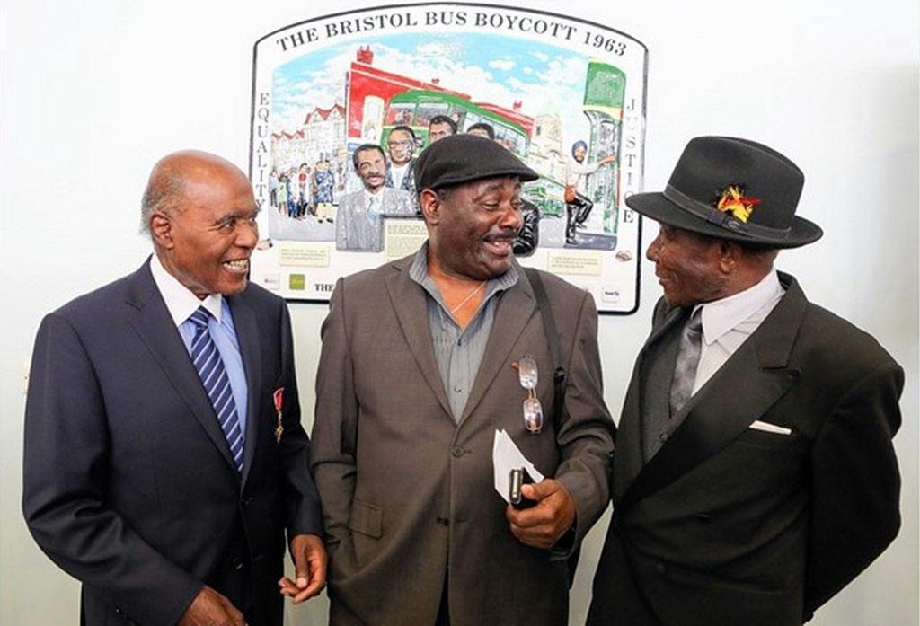 Dr Paul Stephenson, Guy Bailey and Roy Hackett stand in front of a plaque serving as a permanent celebration and reminder of the non-violent campaign to change the Bristol Omnibus Company’s employment laws.