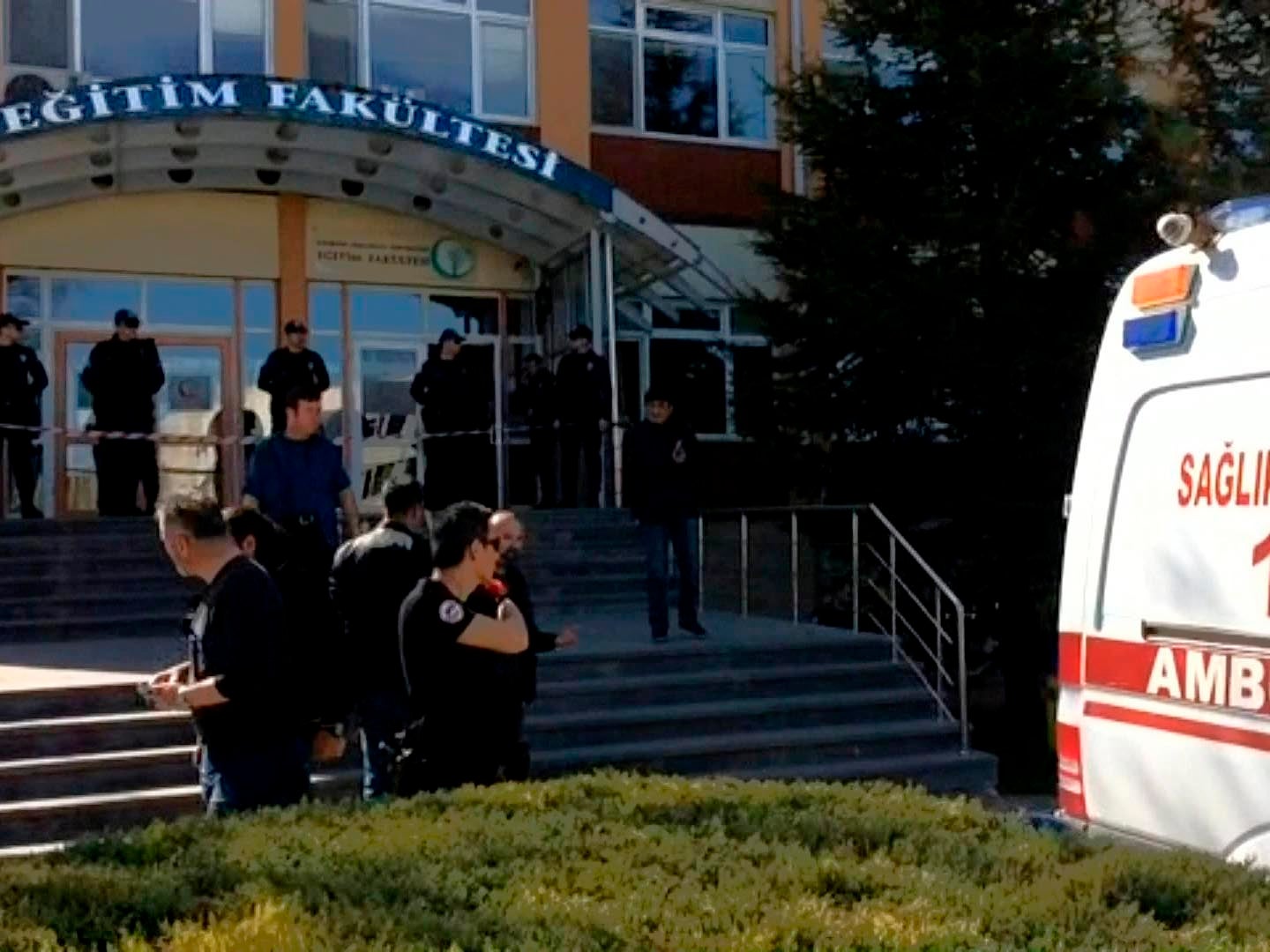 Security officials stand at the entrance of Eskisehir Osmangazi University after shooting