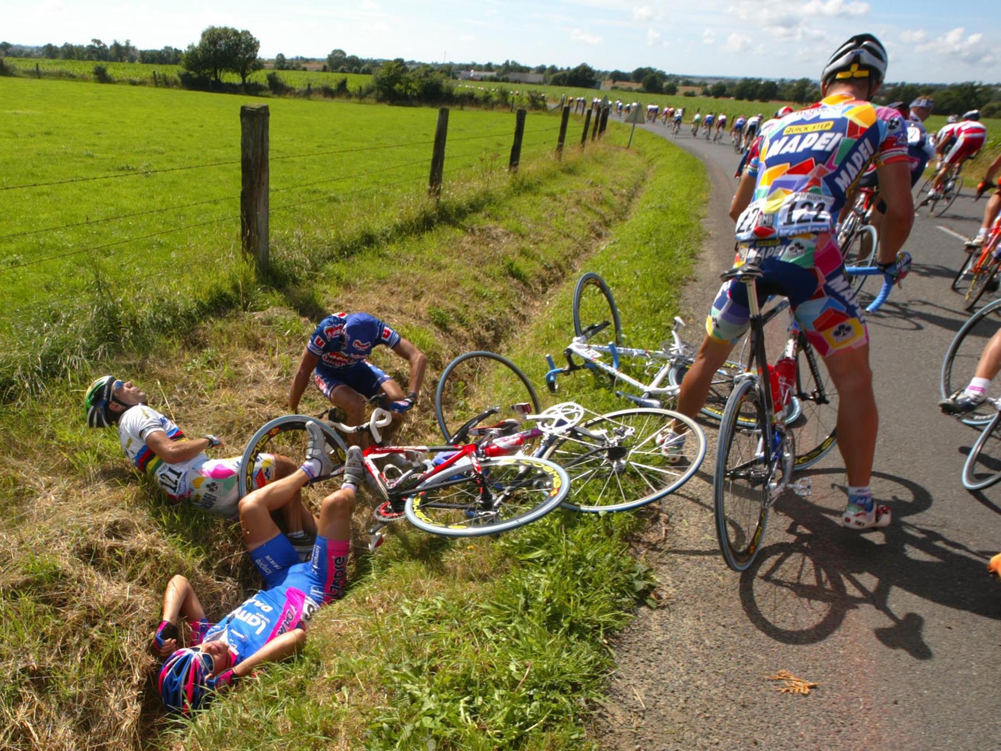 Injured Tour de France riders in a ditch after a crash