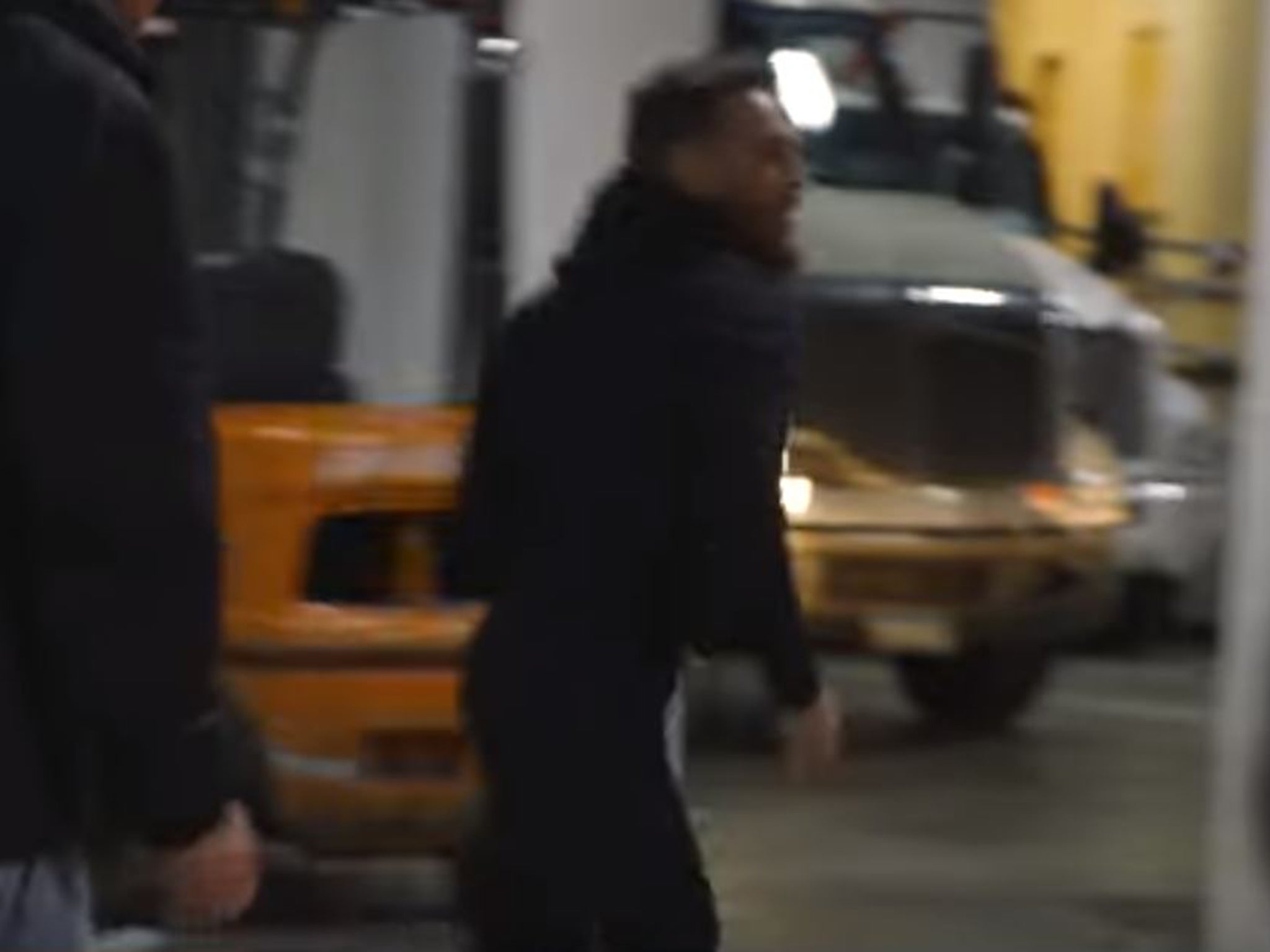 McGregor runs towards the bus with his entourage behind him