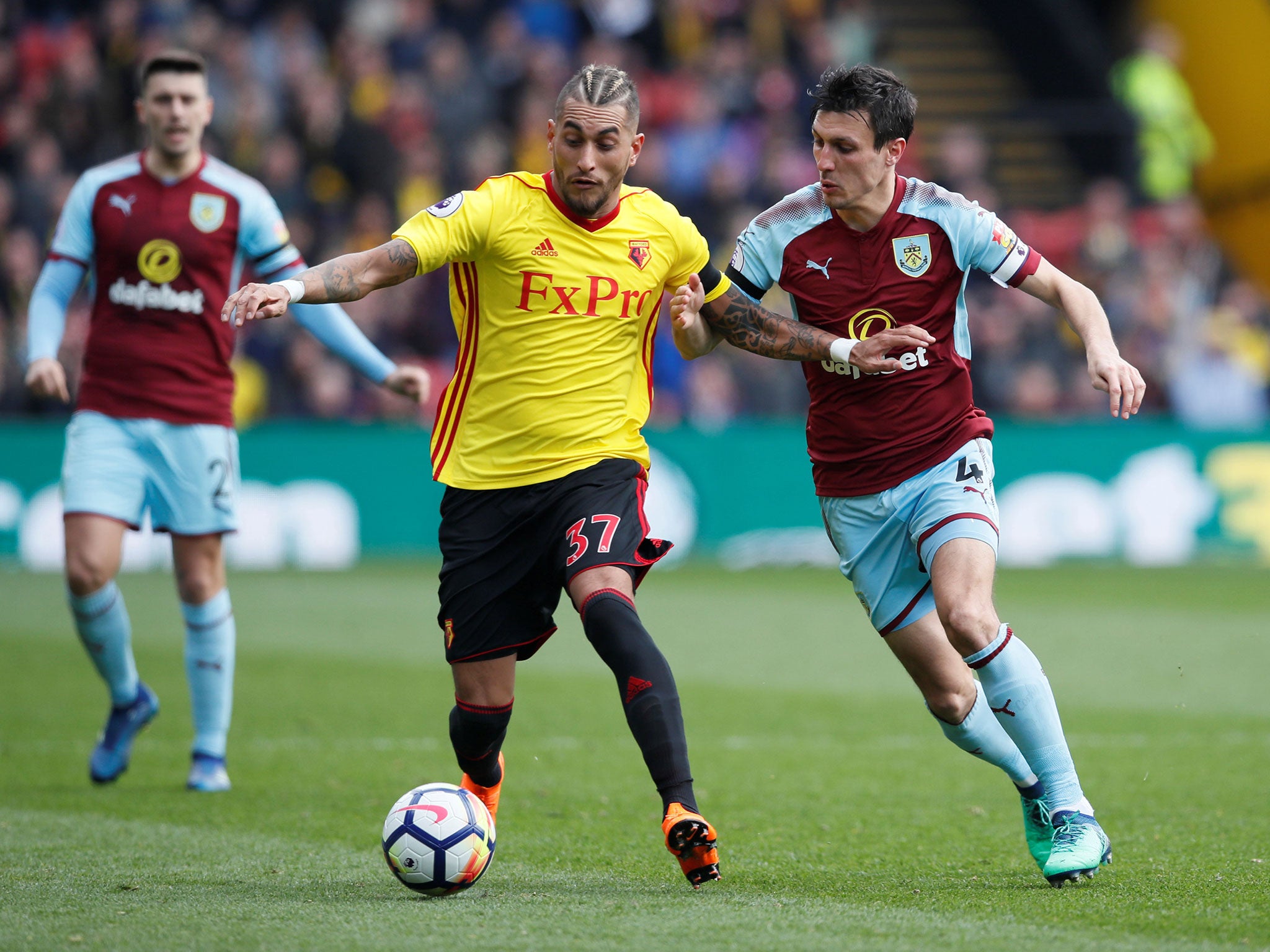 Roberto Pereyra and Jack Cork tussle for possession