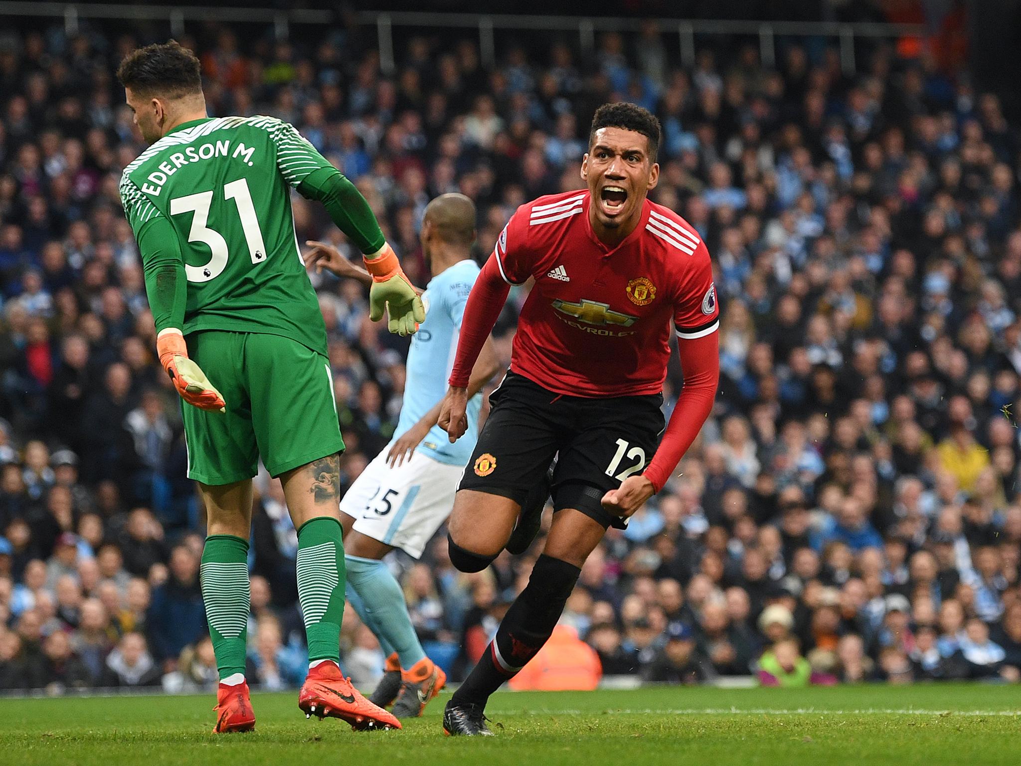 Chris Smalling celebrates after giving Manchester United victory over City