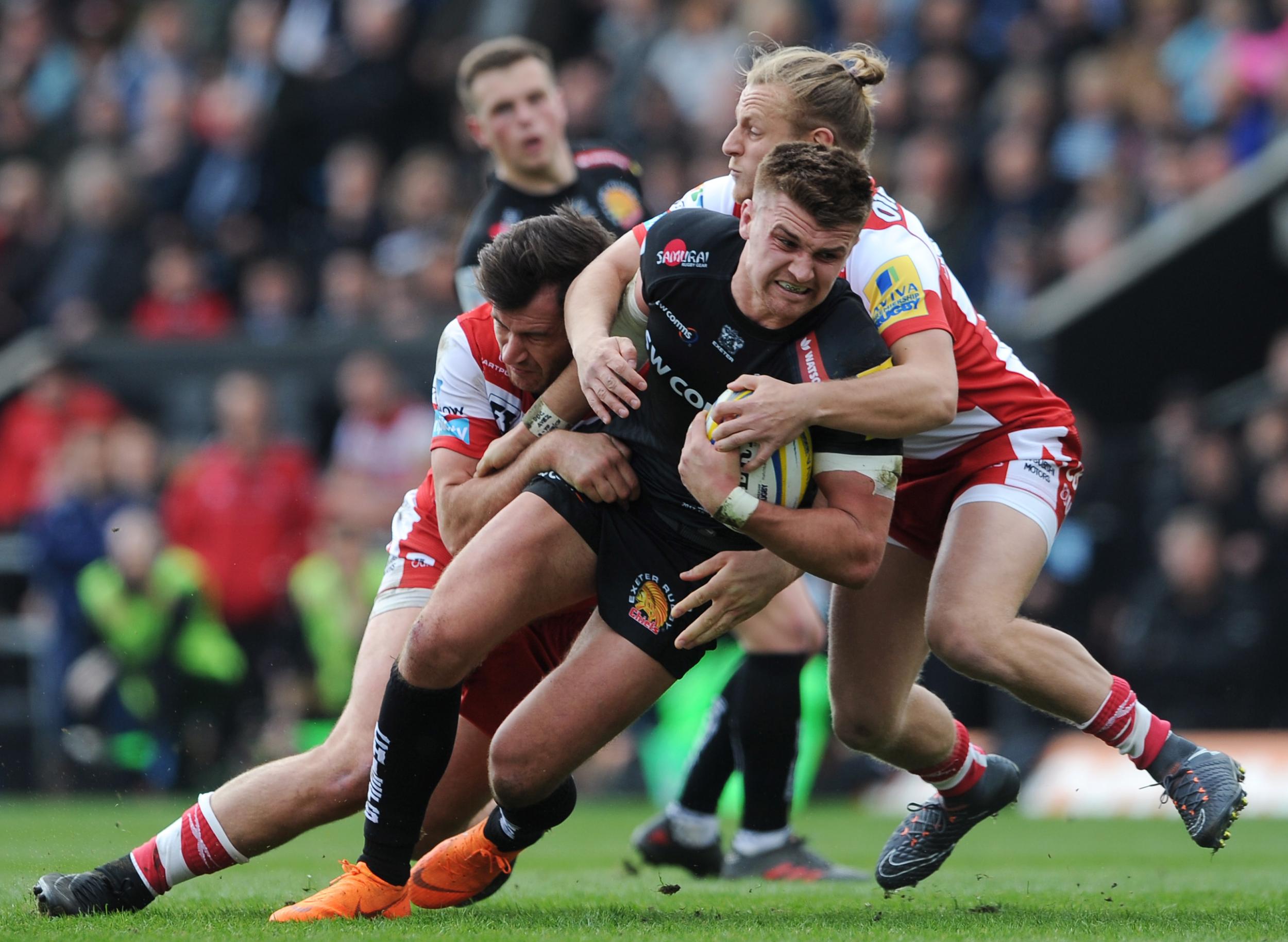 Henry Slade is tackled in midfield