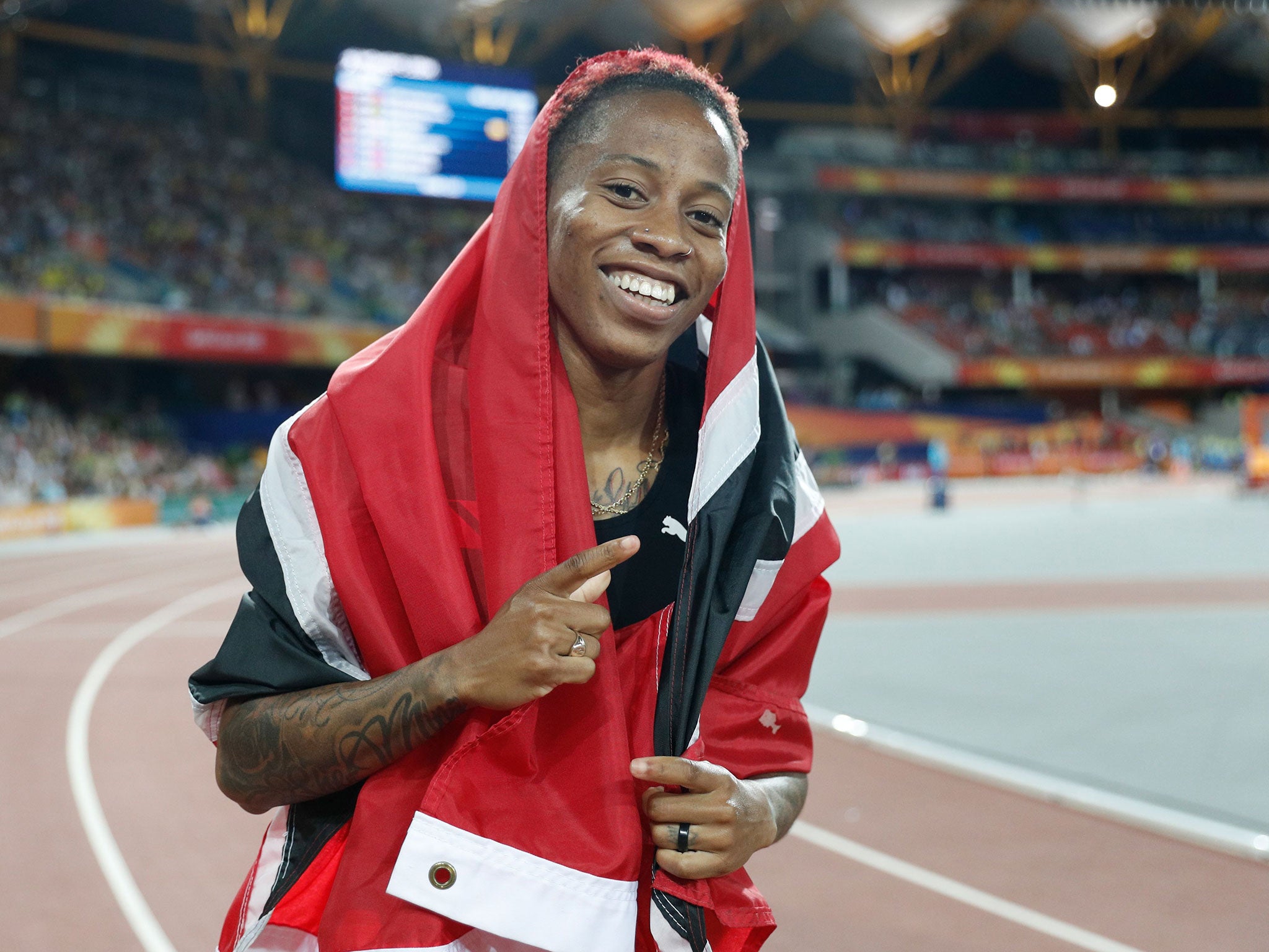 Michelle-Lee Ahye celebrates clinching gold in the women's 100m