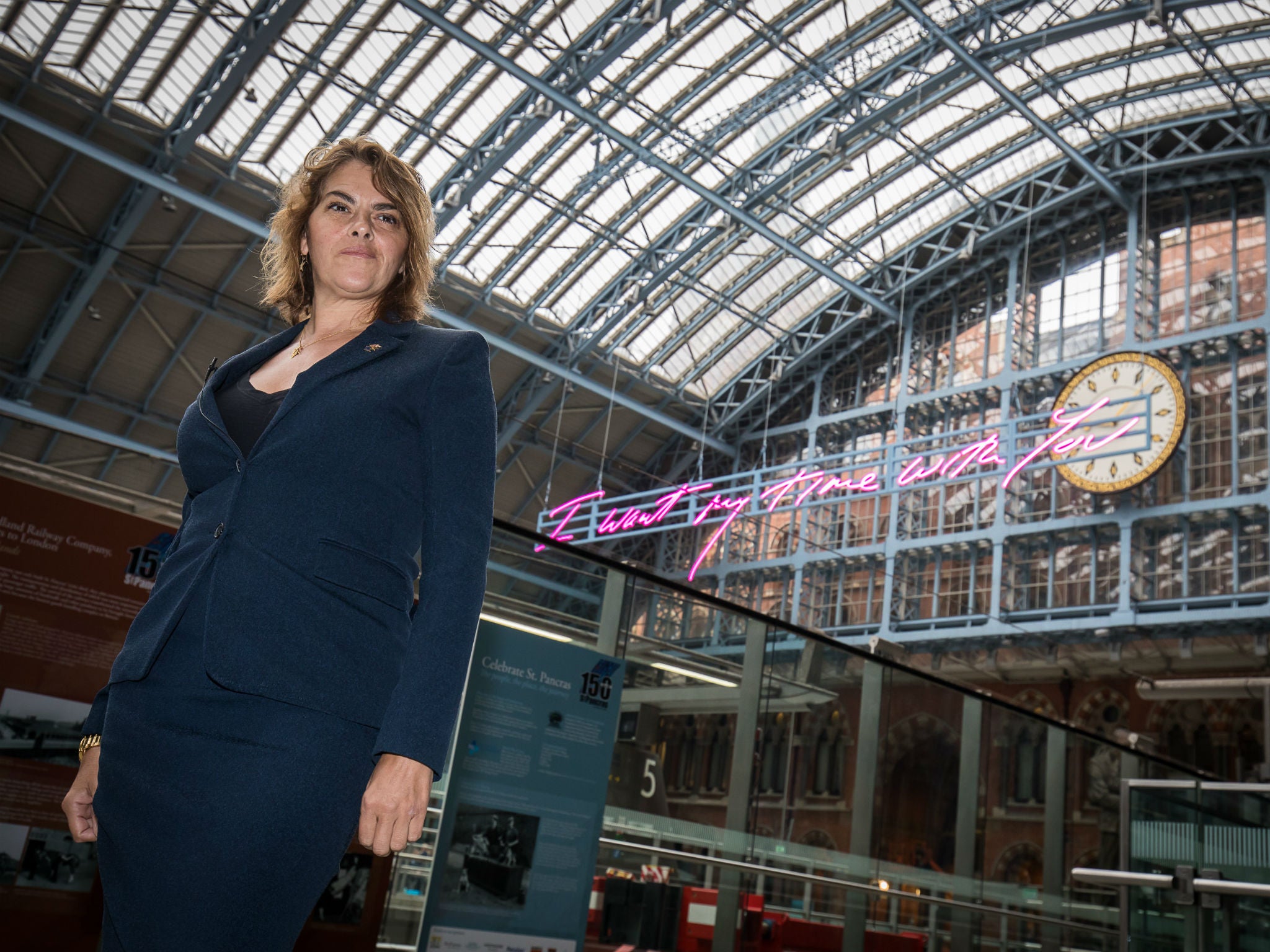 Emin hopes grim-faced travellers smile when they step off the train and see her work