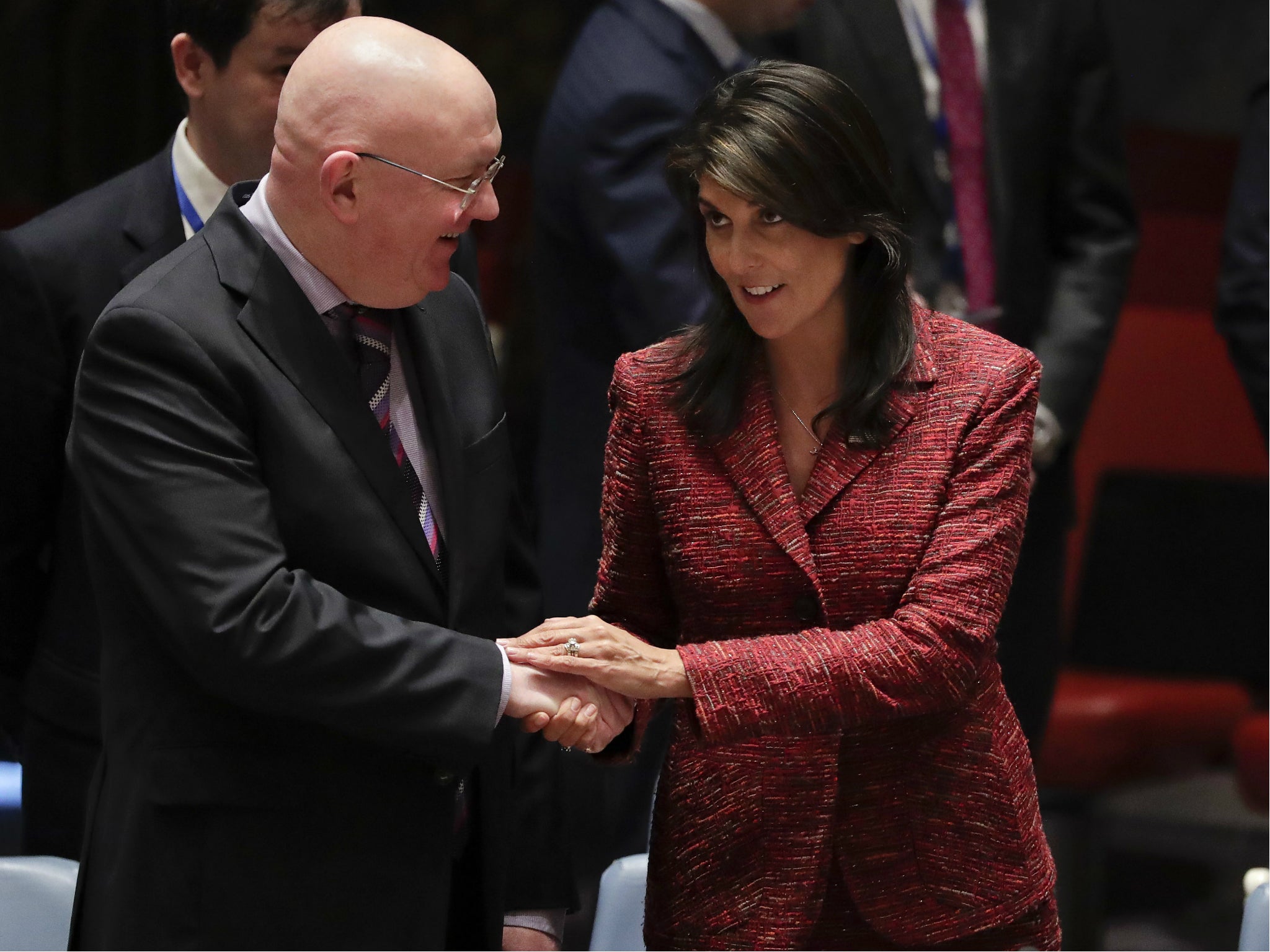 Russian ambassador to the United Nations Vasily Nebenzya, left, and US Ambassador to the UN Nikki Haley shake hands before the Security Council meeting