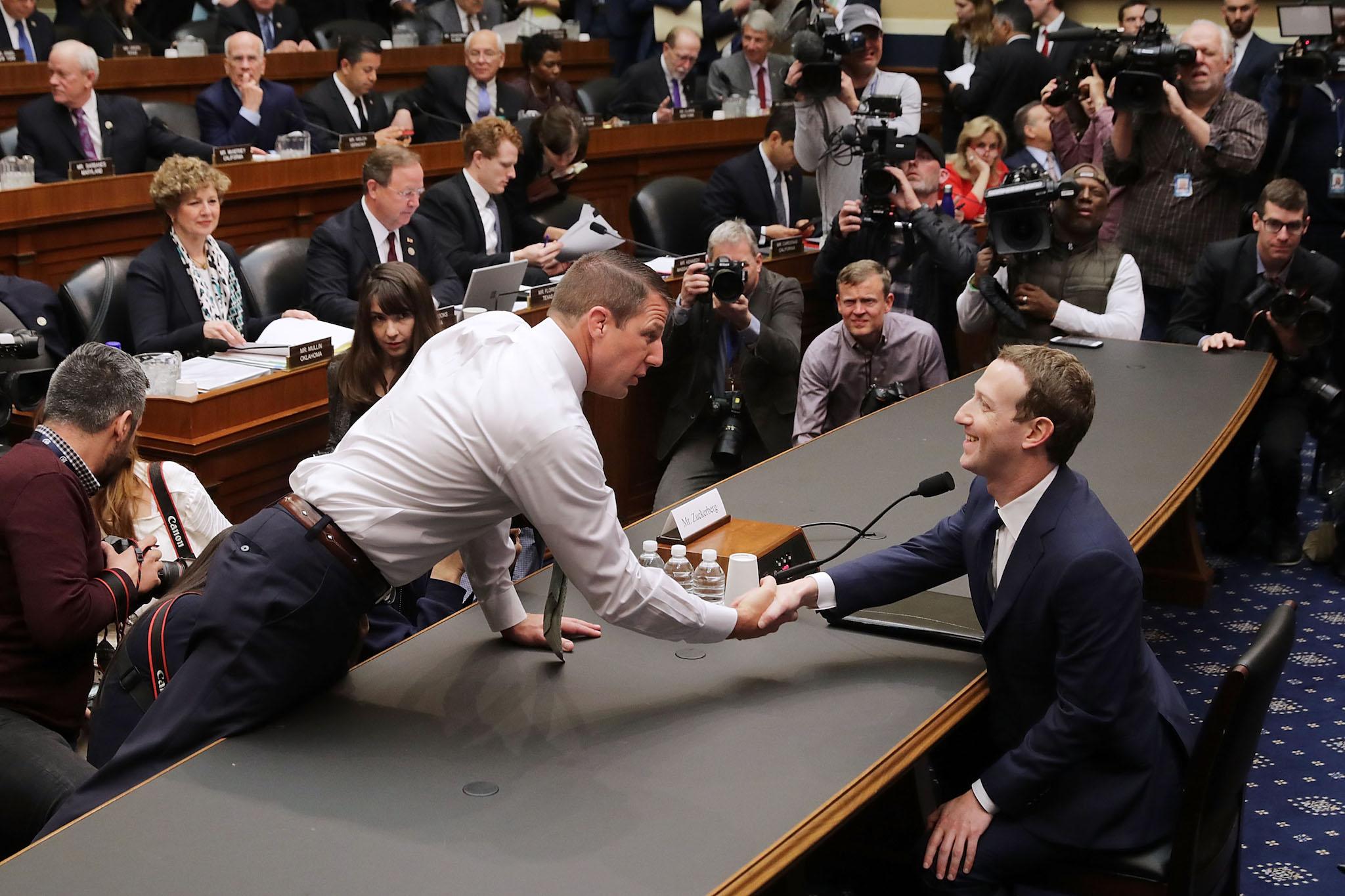 Rep. Markwayne Mullin (R-OK) (L) greets Facebook co-founder, Chairman and CEO Mark Zuckerberg before he testifies to the House Energy and Commerce Committee in the Rayburn House Office Building on Capitol Hill April 11, 2018 in Washington, DC