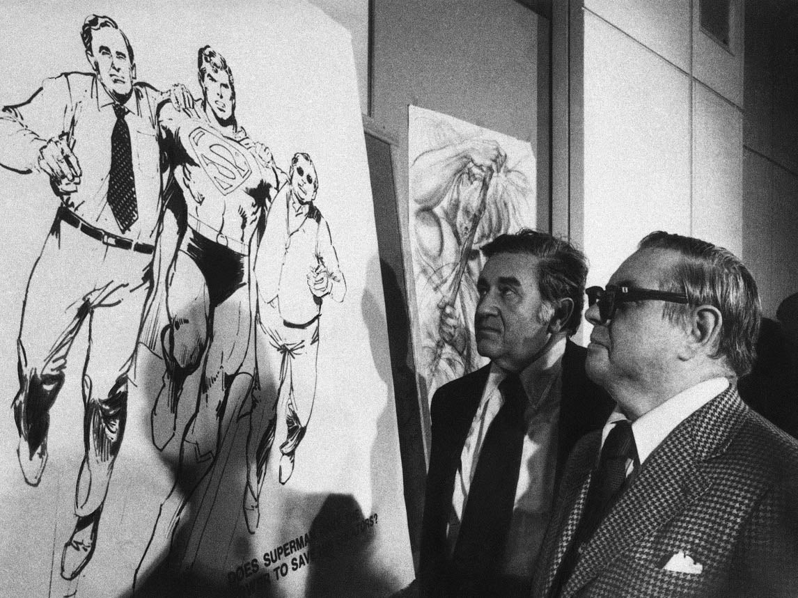 Joe Shuster (left) and writer Jerry Siegel examine a sketch of Superman rescuing them at a meeting of professional cartoonists in New York in December 1975